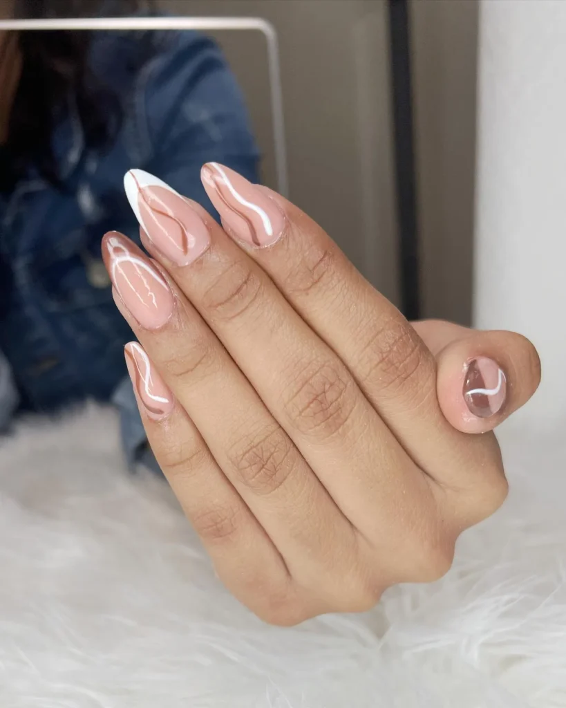 soft white French tip almond nails over a warm nude base for fall