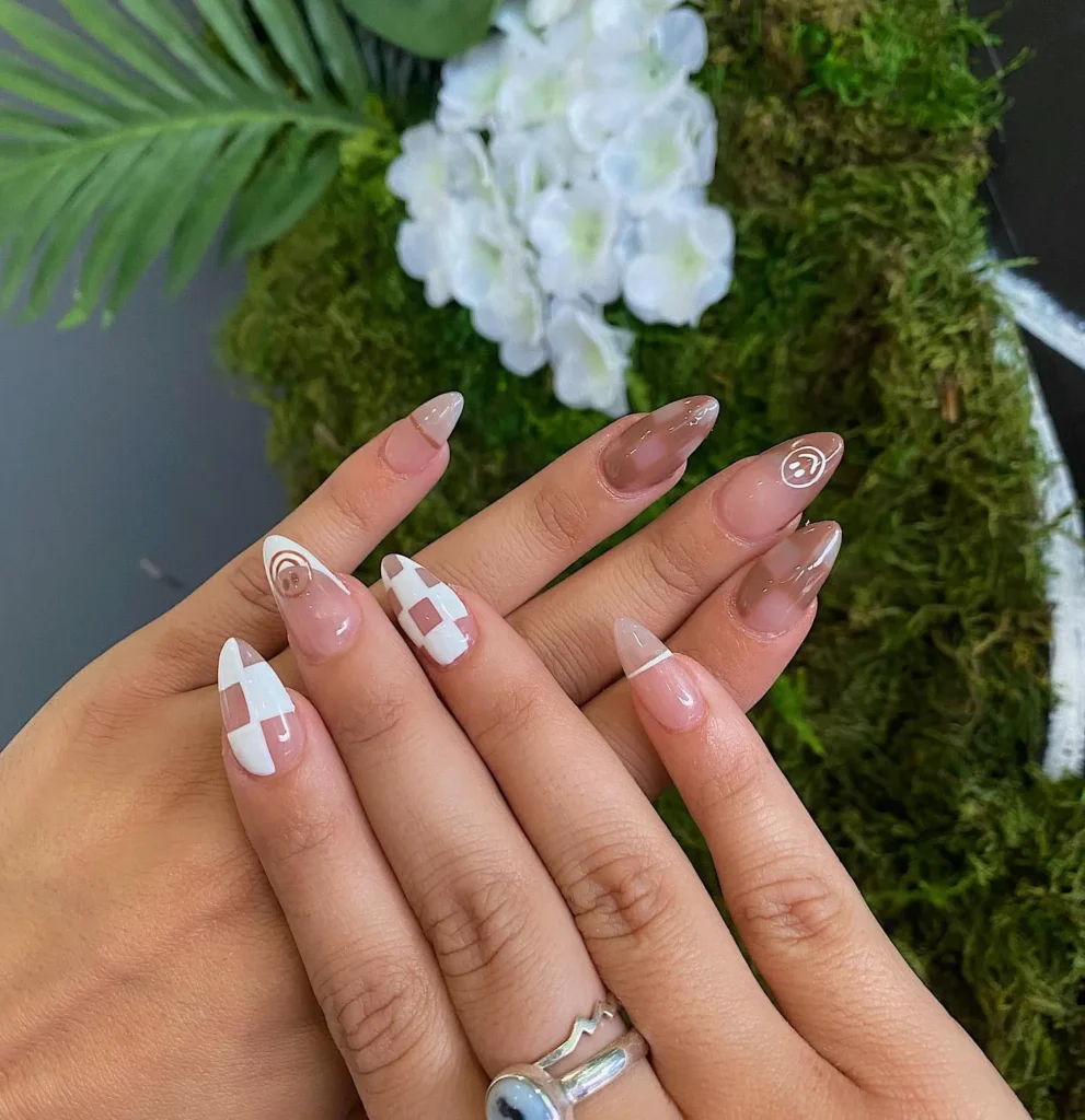 warm taupe almond nails with a thin deep brown French edge