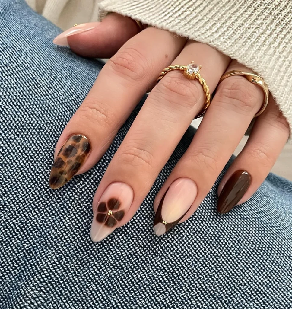 fine-line cocoa botanical art almond nails with a satin finish