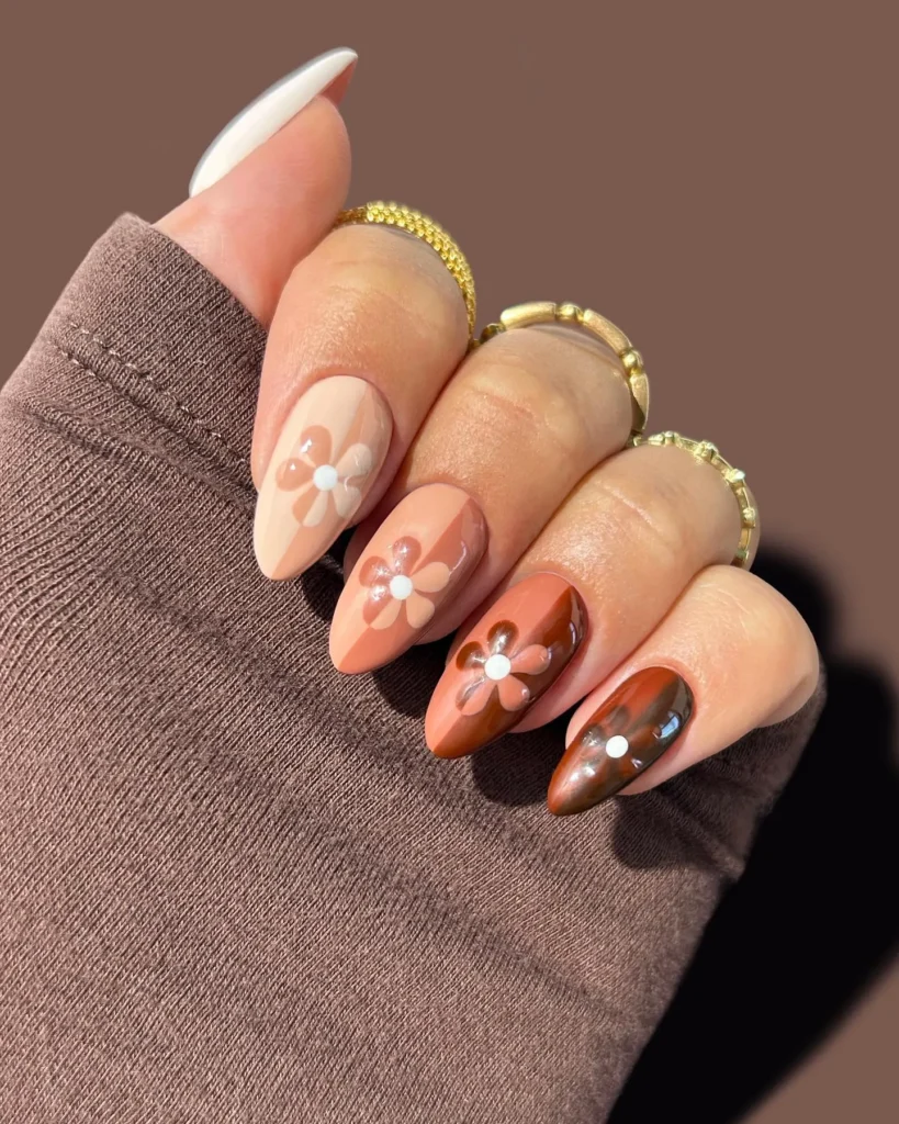 hand-painted chocolate brown floral almond nails over a lighter brown base