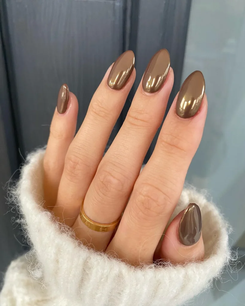 cappuccino brown chrome almond nails with a soft mirror shine