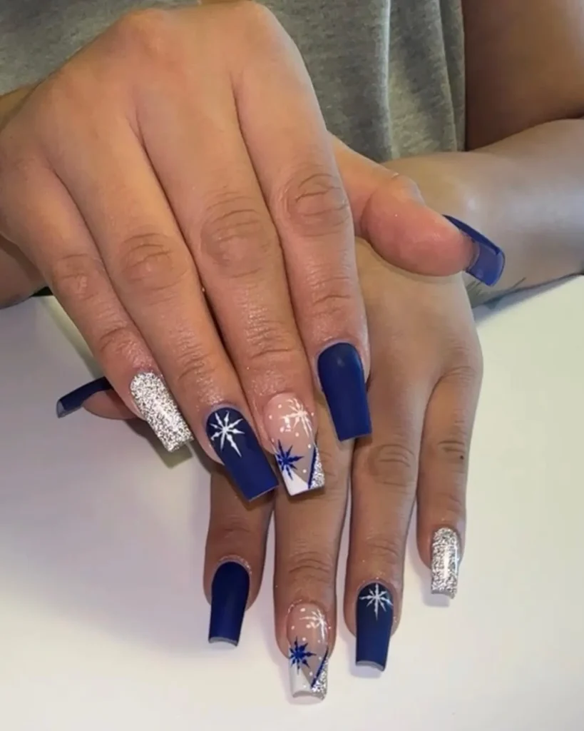 navy blue christmas almond nails with white snowflakes