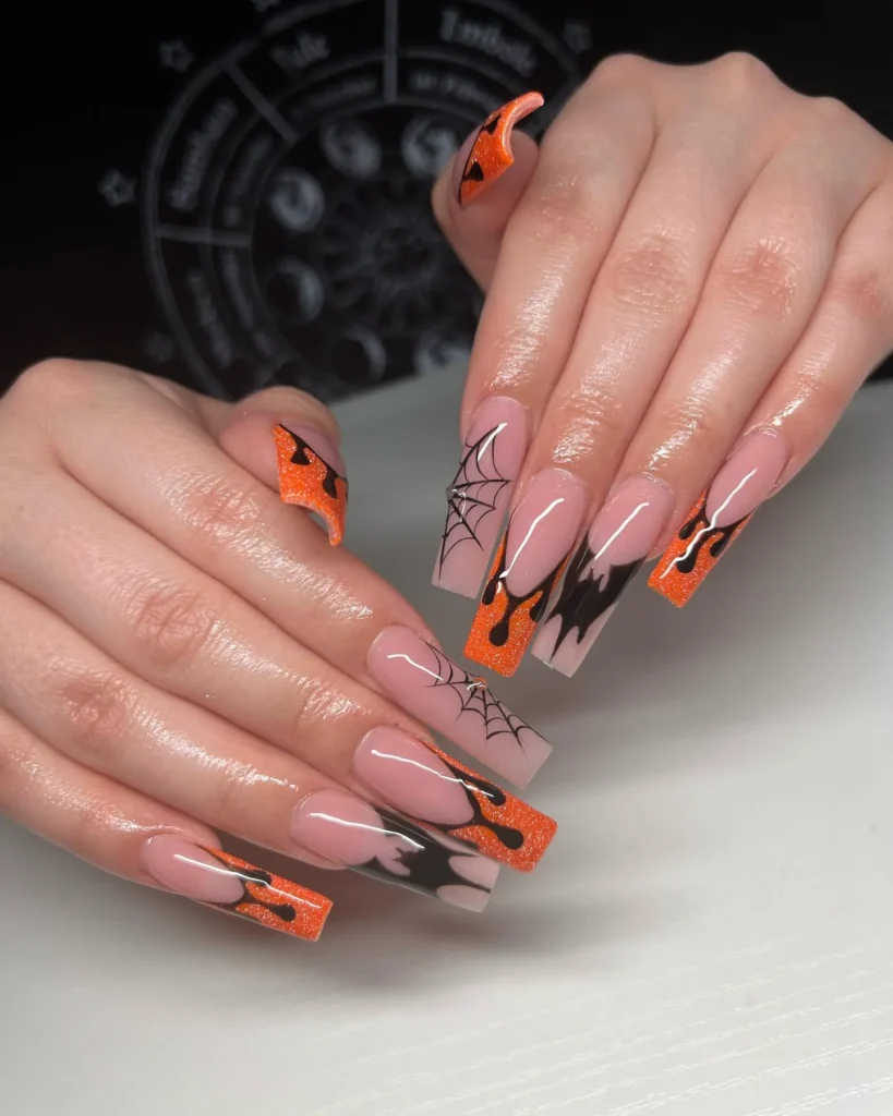 high-contrast orange and black French tip almond nails