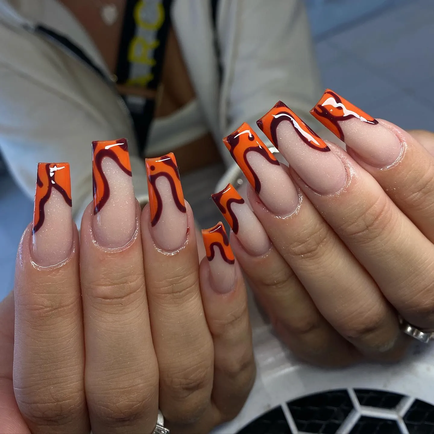Orange and Black Wavy French Tip Coffin Nails