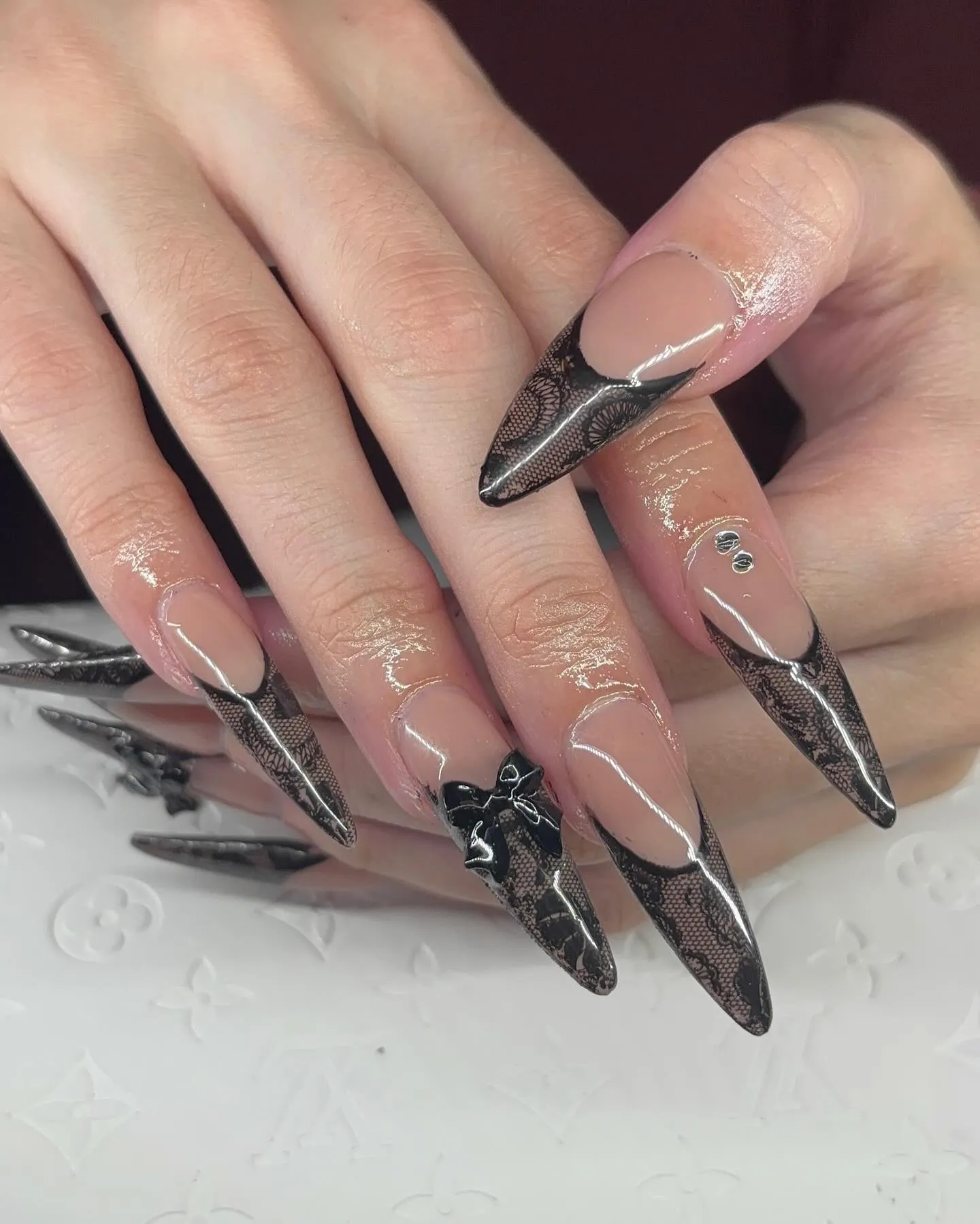 Matte Black Stiletto Nails with Lace Accents