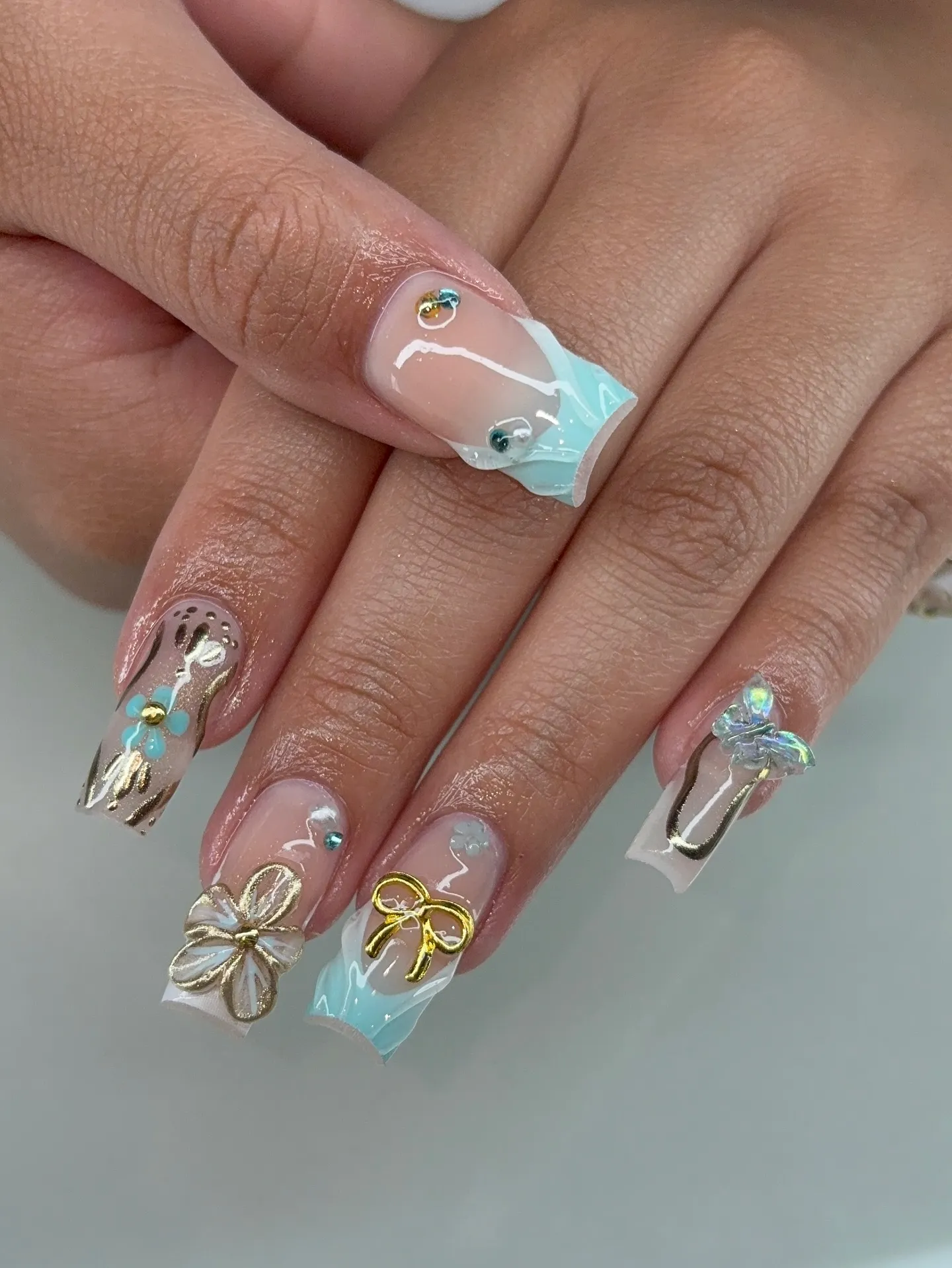 Mint green nails with gold accents