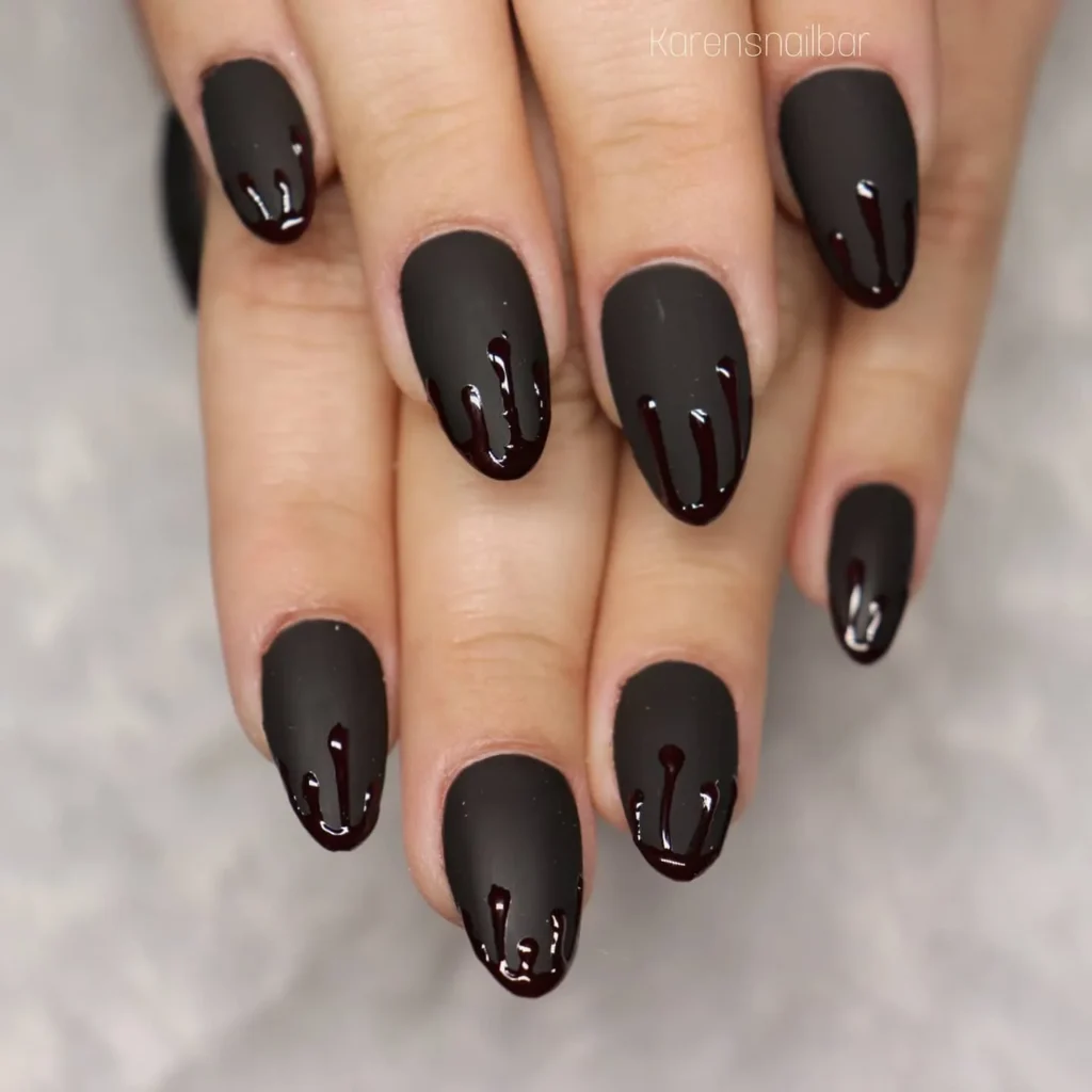 matte black long almond nails with a dripping paint art design