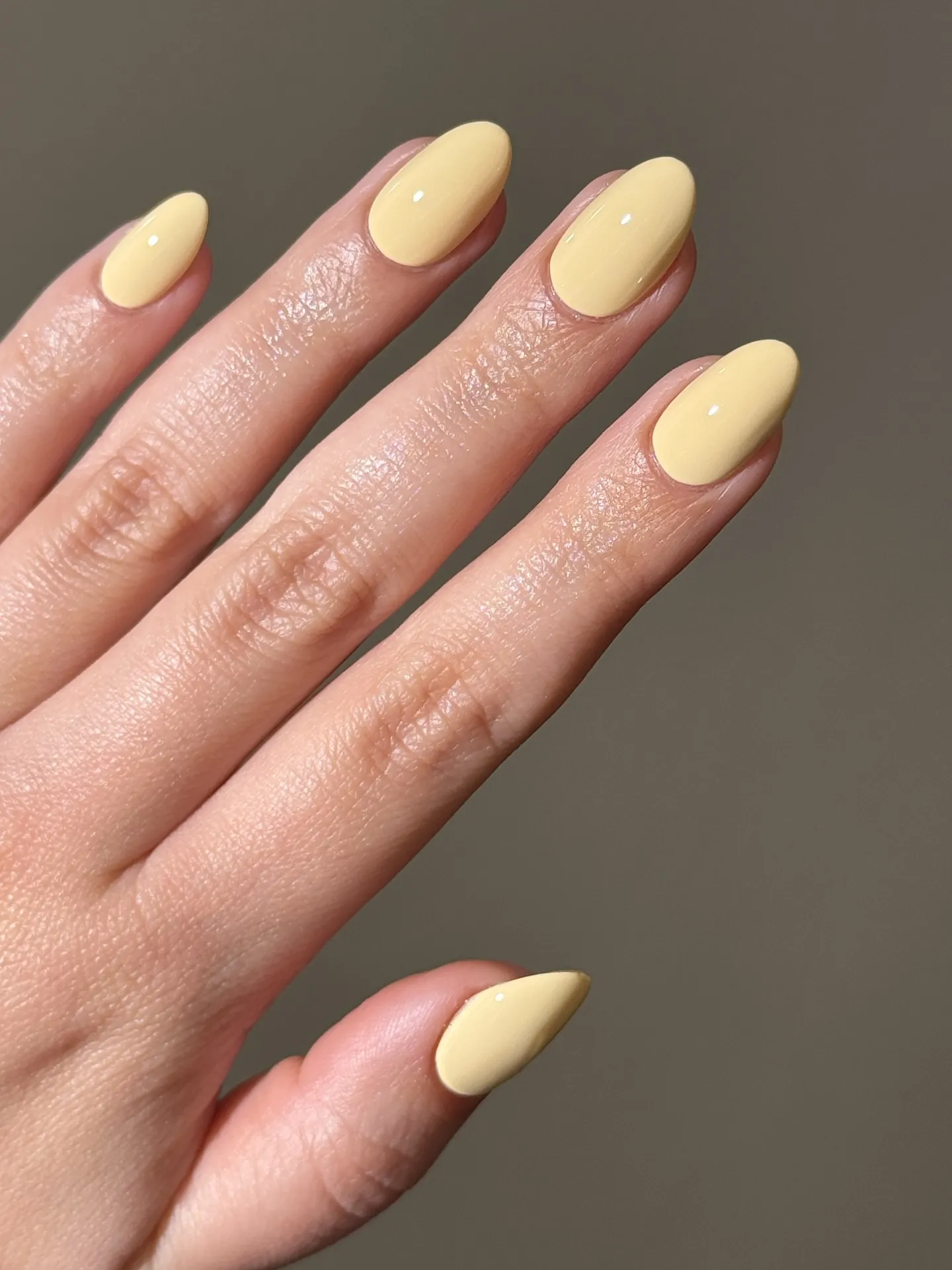 Glossy butter yellow almond nails
