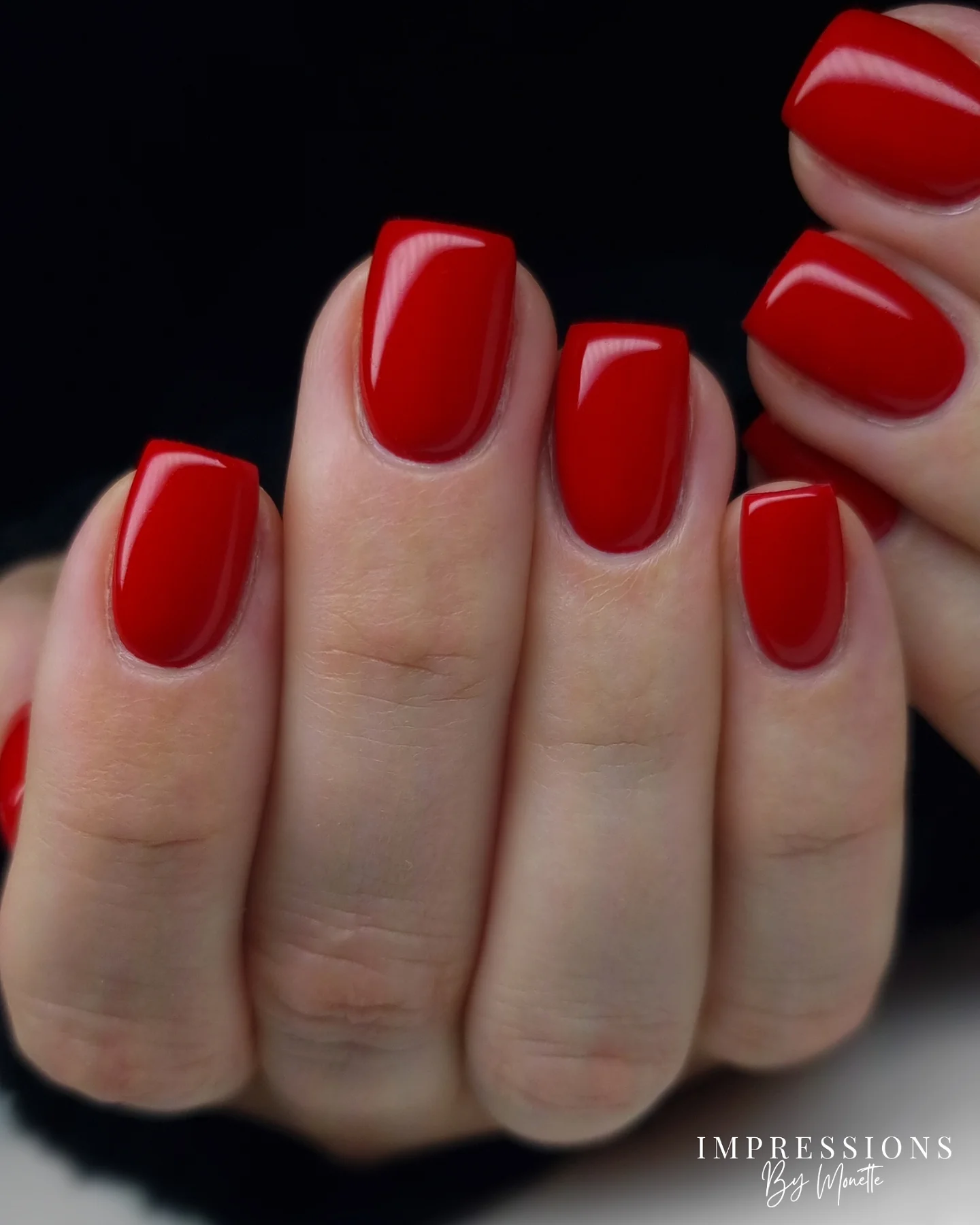 Short square nails in glossy cherry red