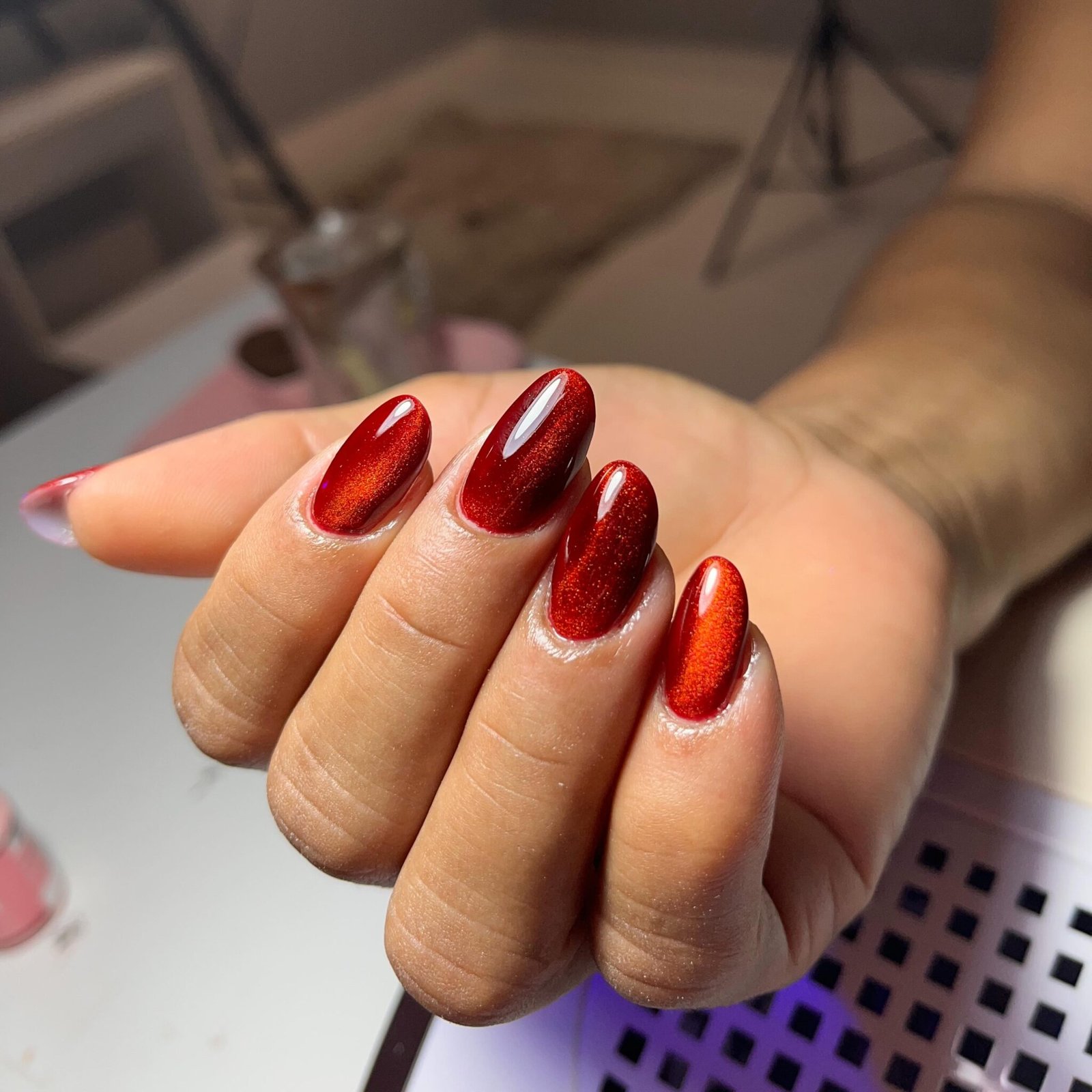 Ruby red cat-eye sheen on almond nails