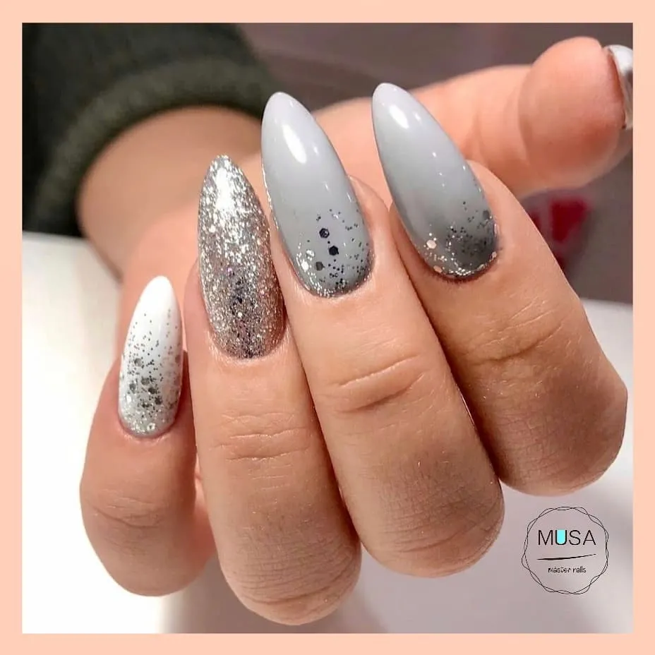 gray glitter ombre almond nails with a white glitter accent