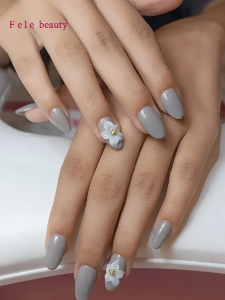 soft gray almond nails with a 3D white flower