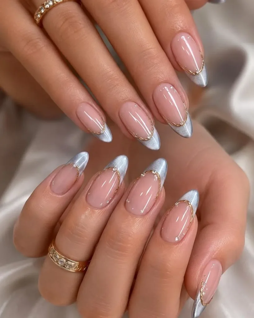 silver chrome French tip almond nails with gold detailing