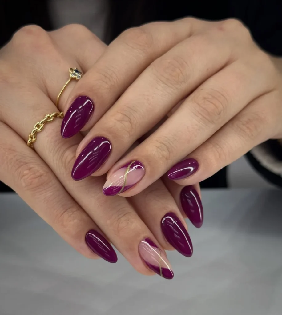 deep plum purple negative-space swirl almond nails with a gold accent