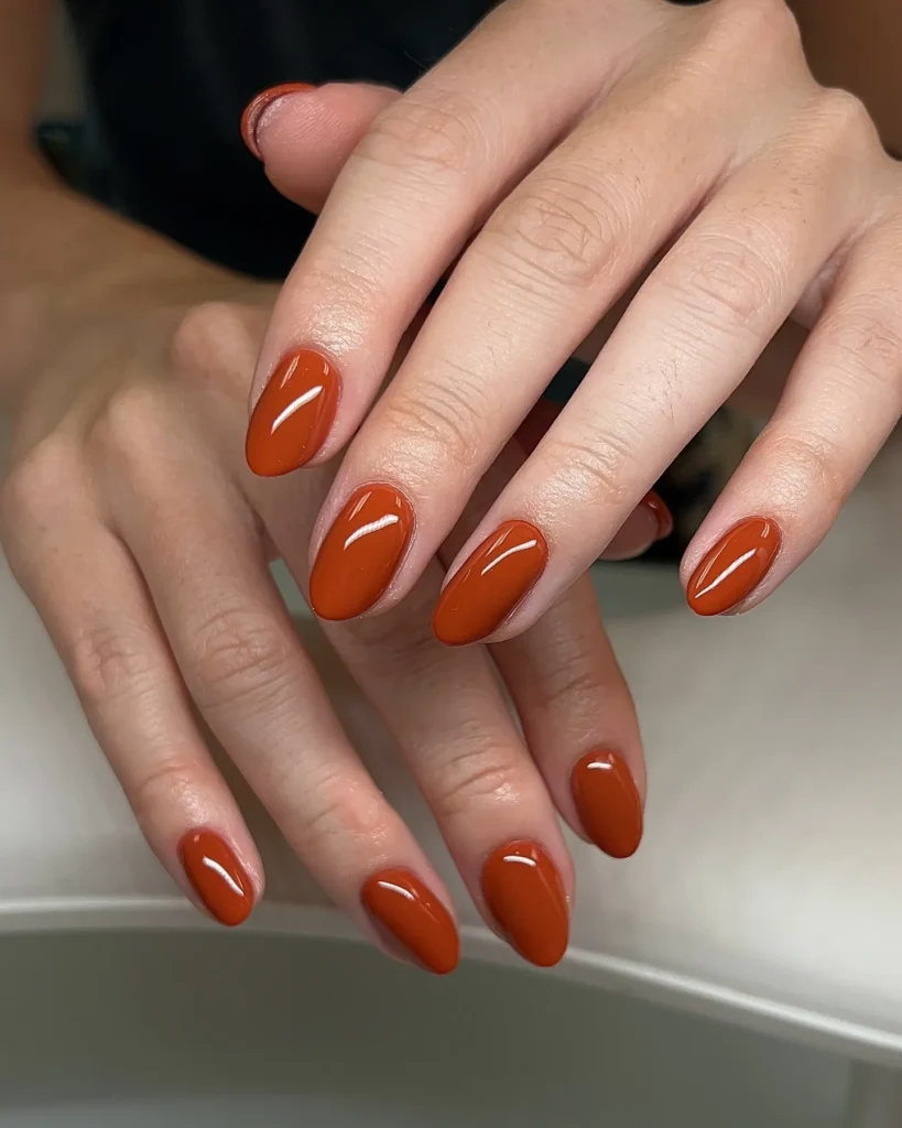 burnt orange glossy solid almond nails