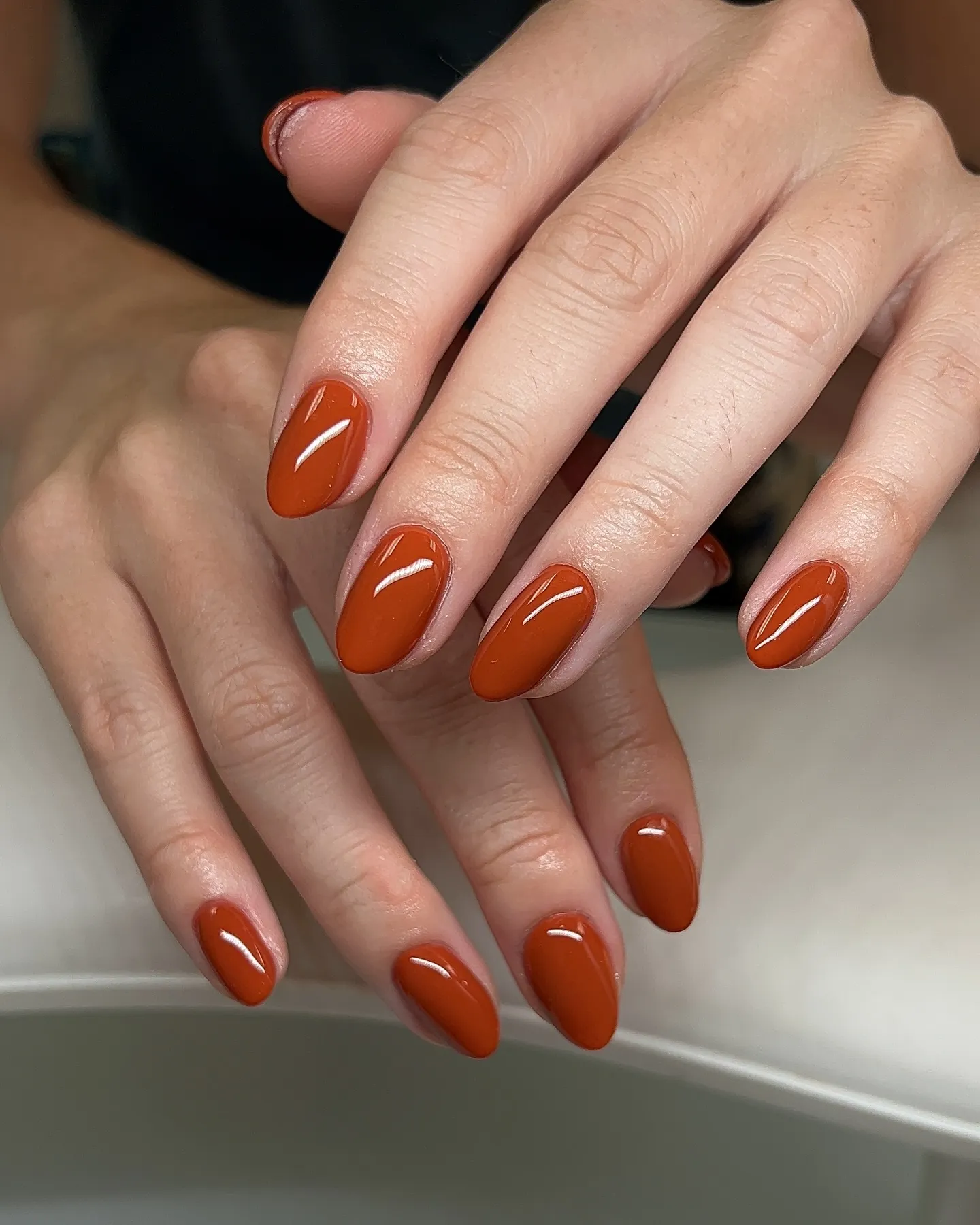 burnt orange glossy solid almond nails