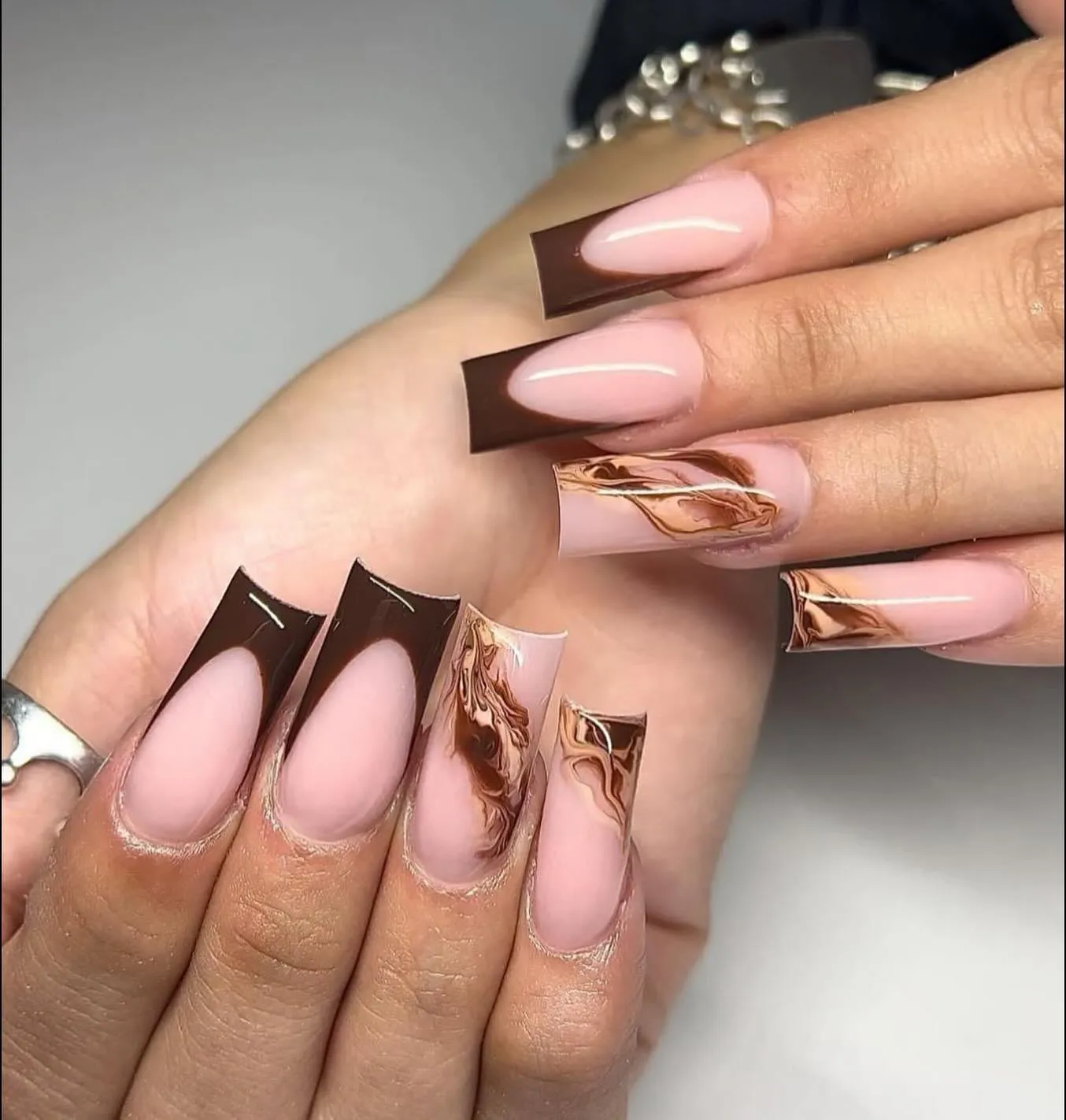 Brown and cream marble accents on long coffin nails