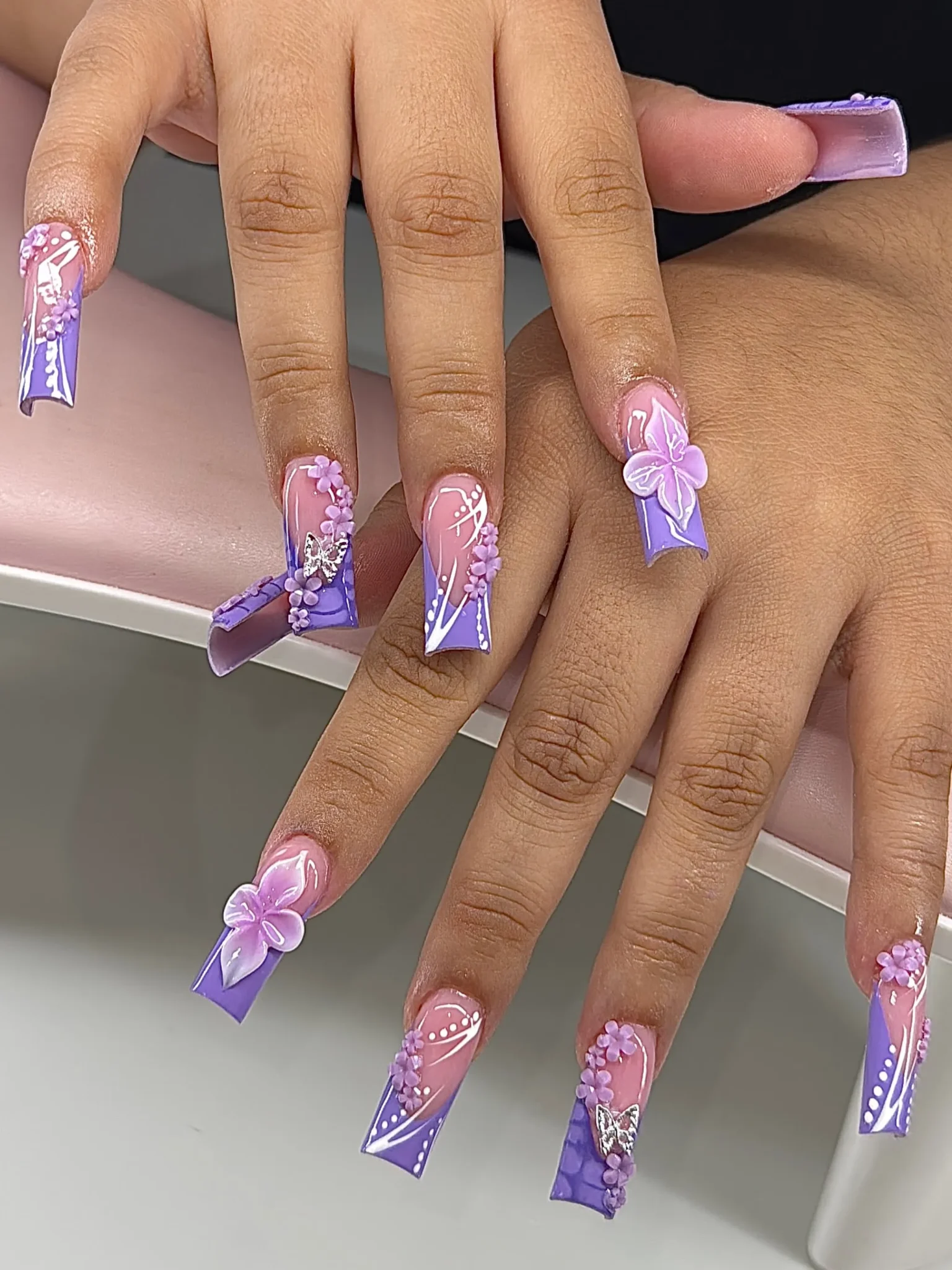Purple coffin nails with raised butterfly charms