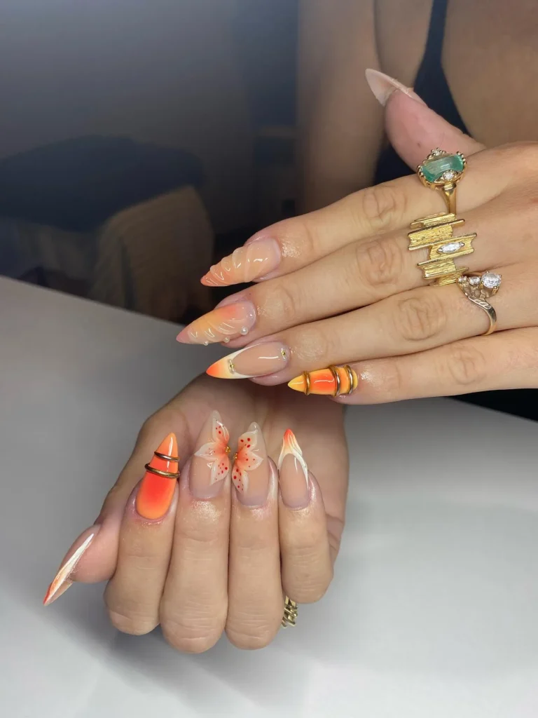 orange almond nails with negative-space geometric linework and a butterfly accent