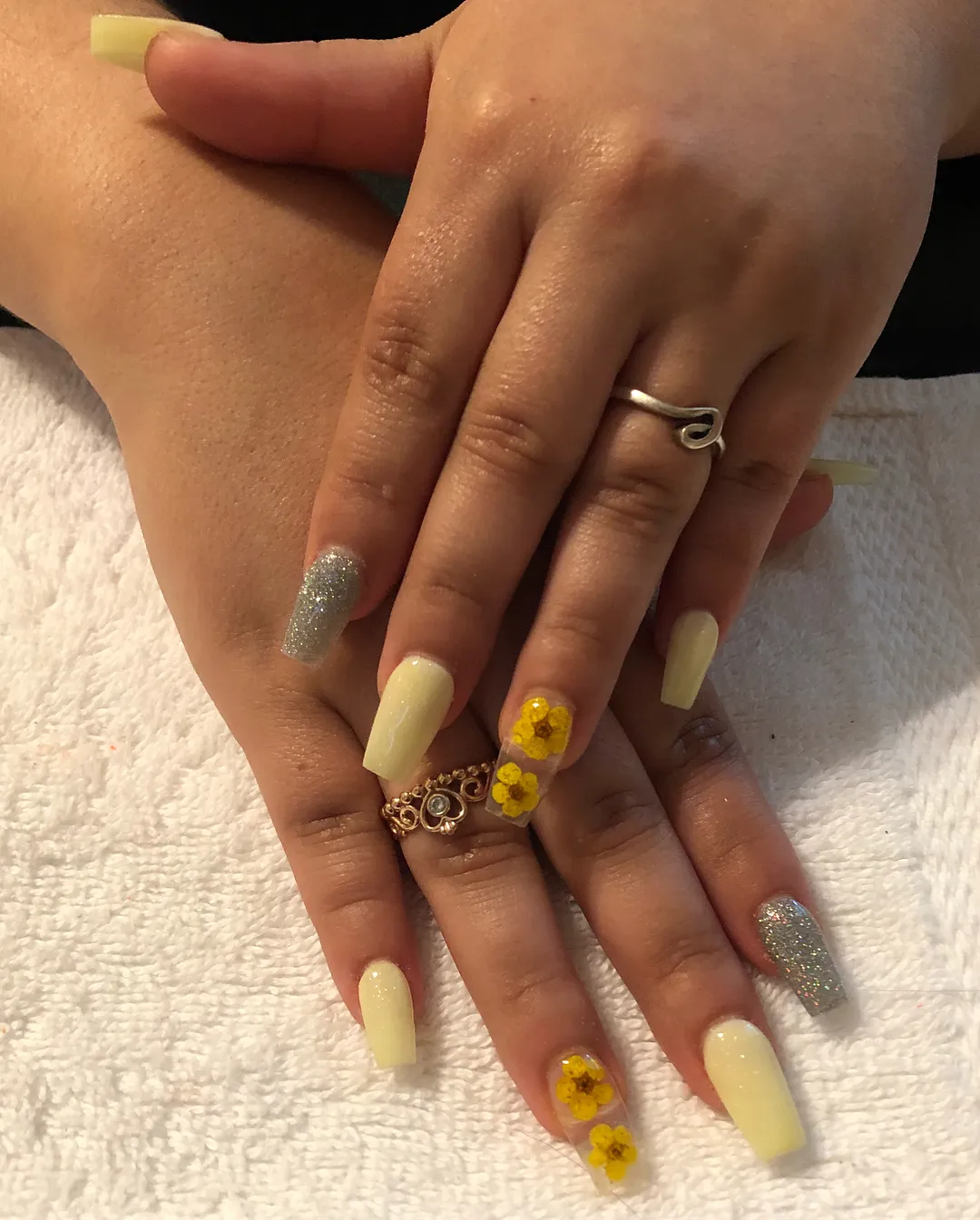 Yellow flower embellishments on pale yellow coffin nails