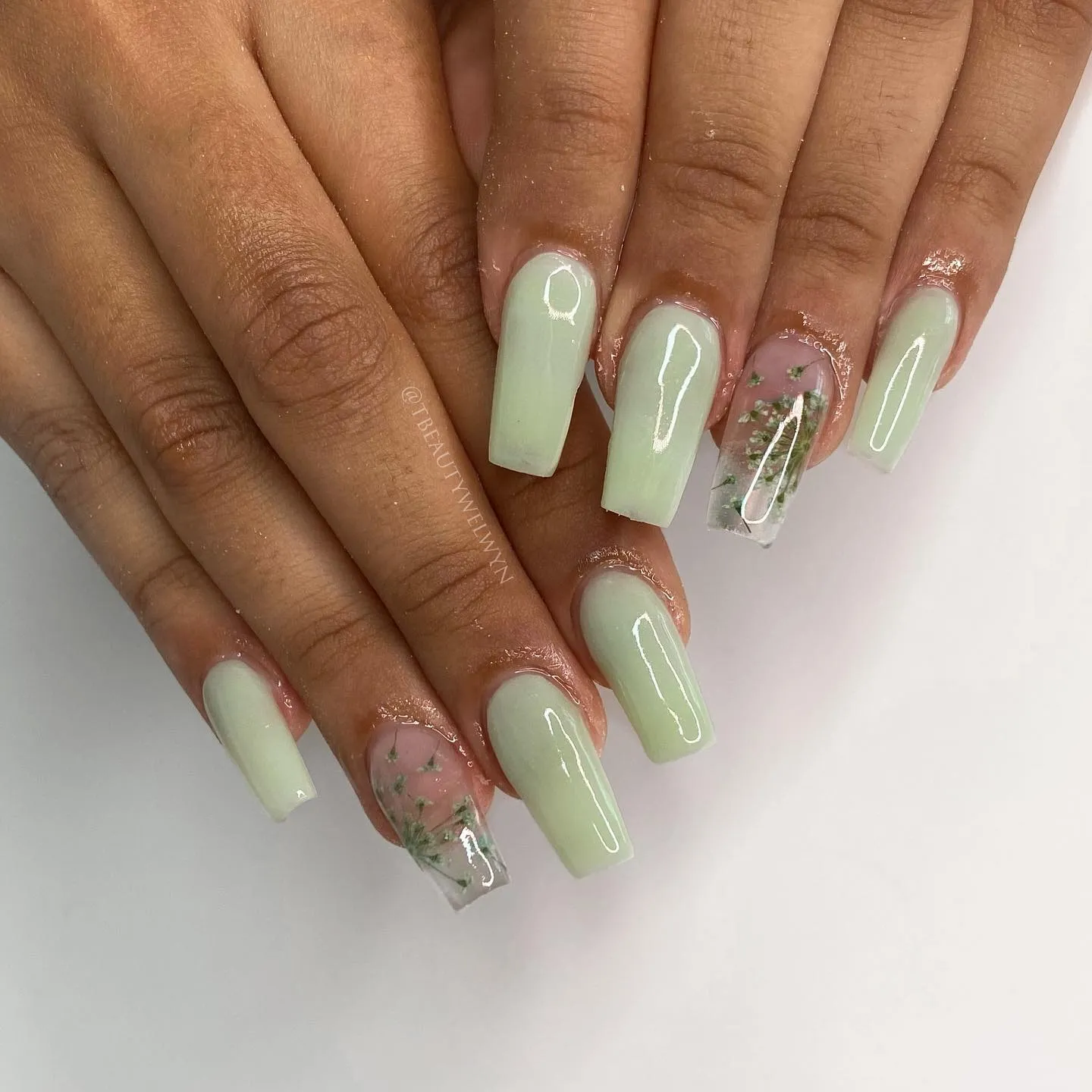 Pressed botanical flowers in clear gel with mint green nails