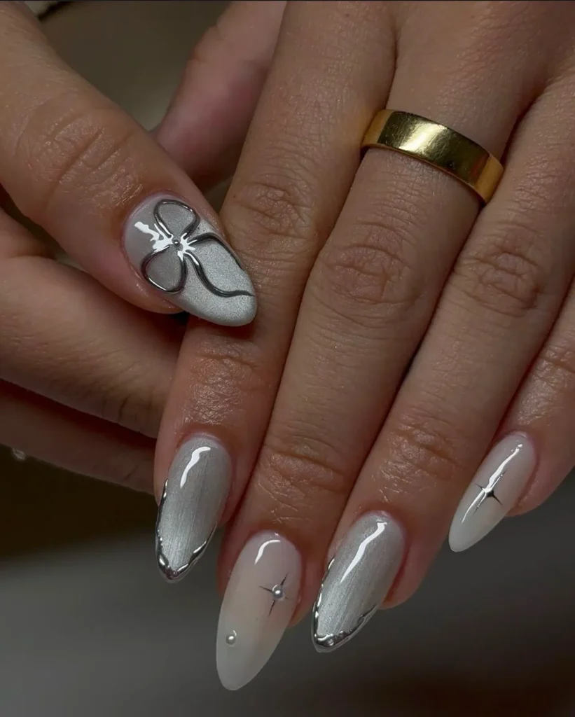 silver metallic almond nails with hand-painted white flower accent