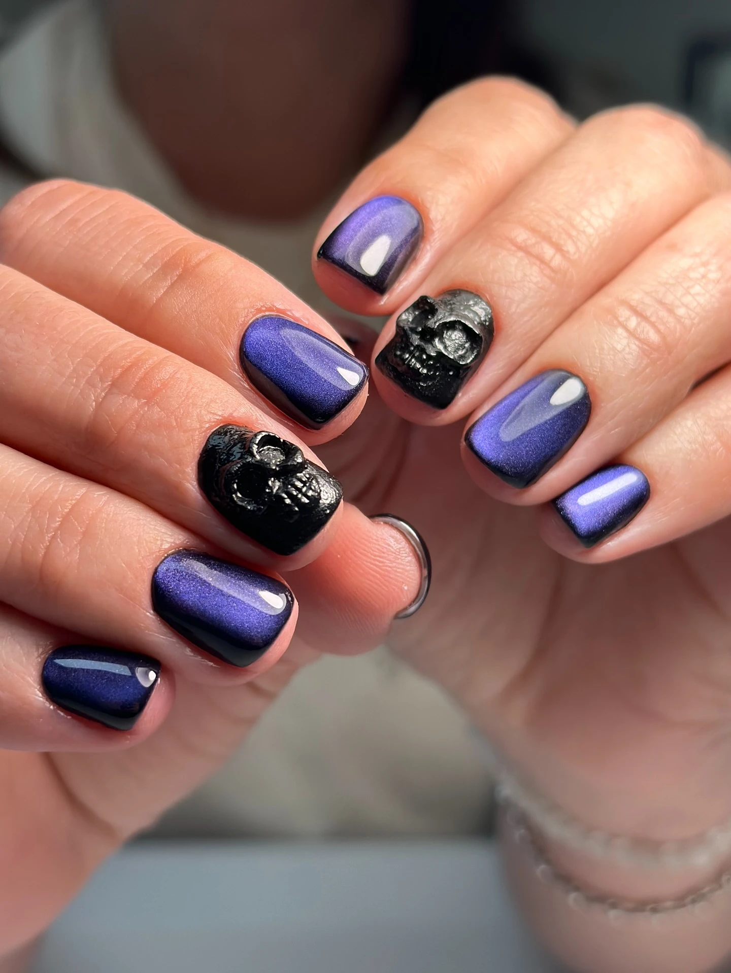 Purple magnetic short nails with black skull accents