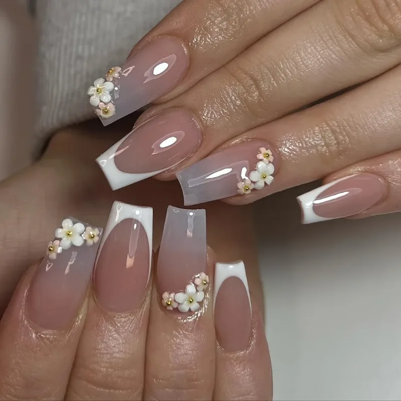 Coffin nails with a nude base, white French tips and small pearl flowers