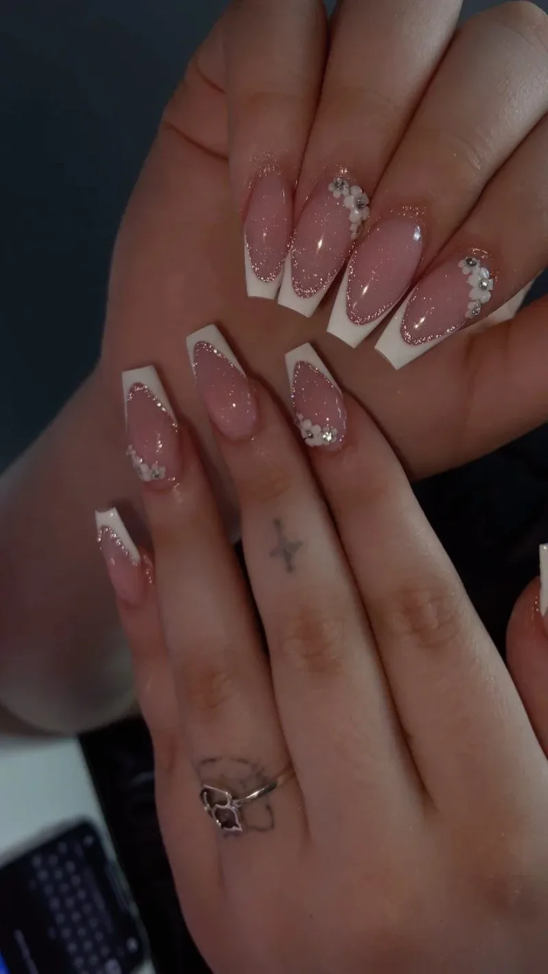 Short nude nails with thin white French tips and tiny details