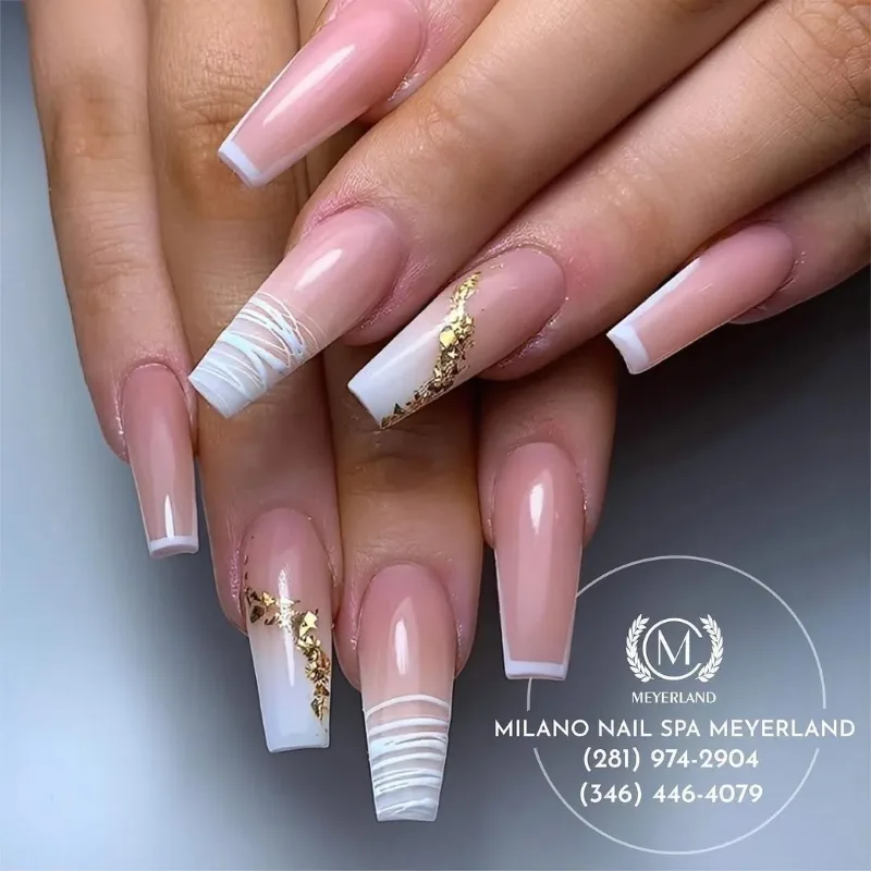 Long coffin nails with white striped ombre tips and gold foil accents