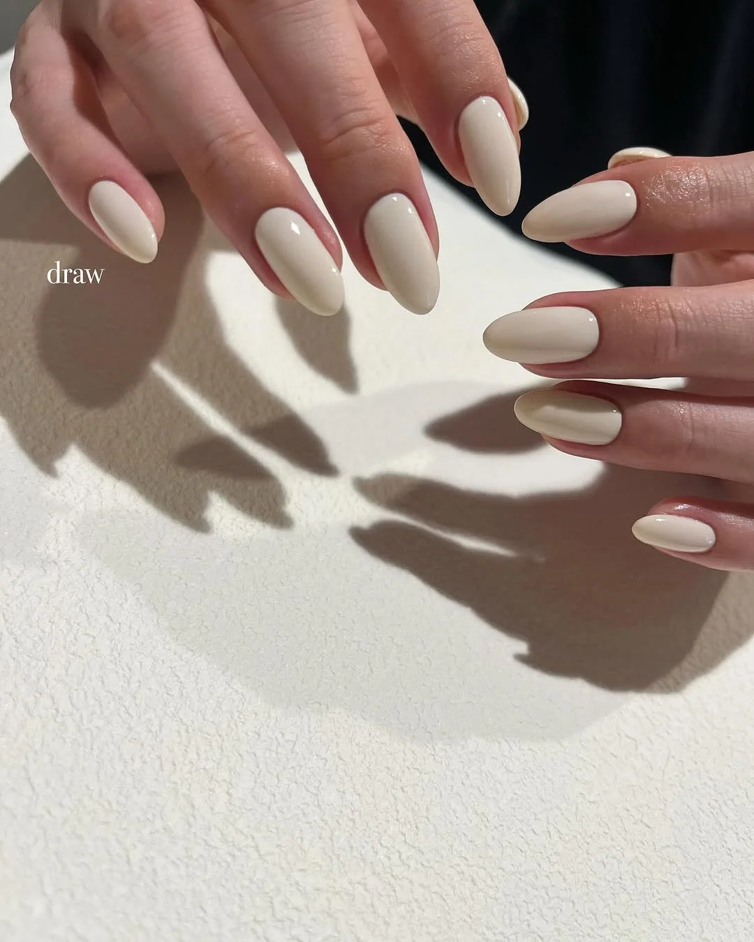 Soft ivory matte almond nails in a neutral beige tone