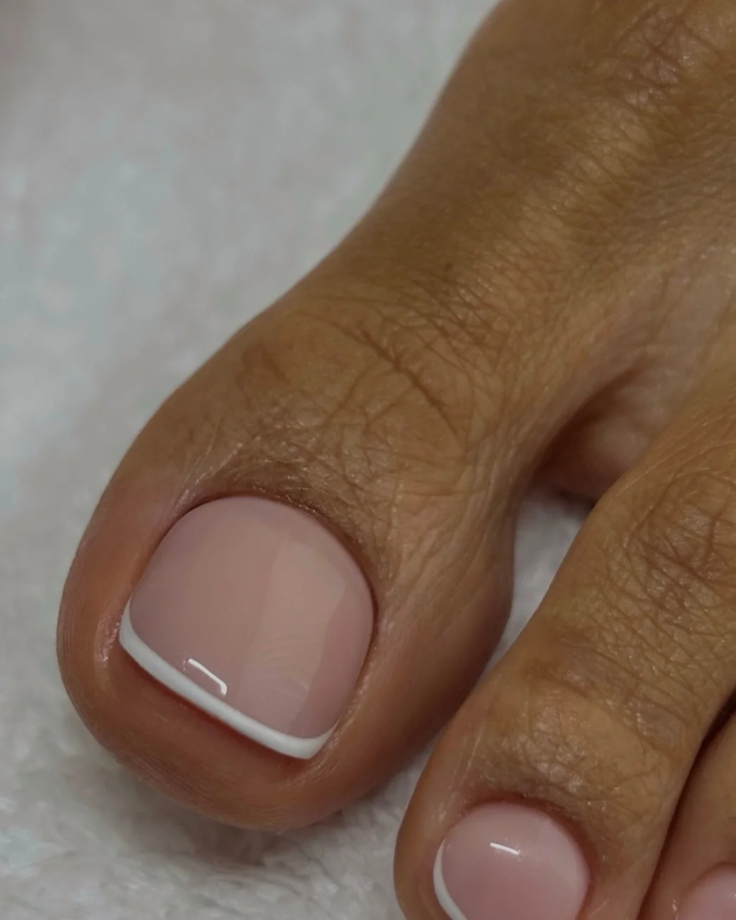 Natural big toenail with a thin white French tip line