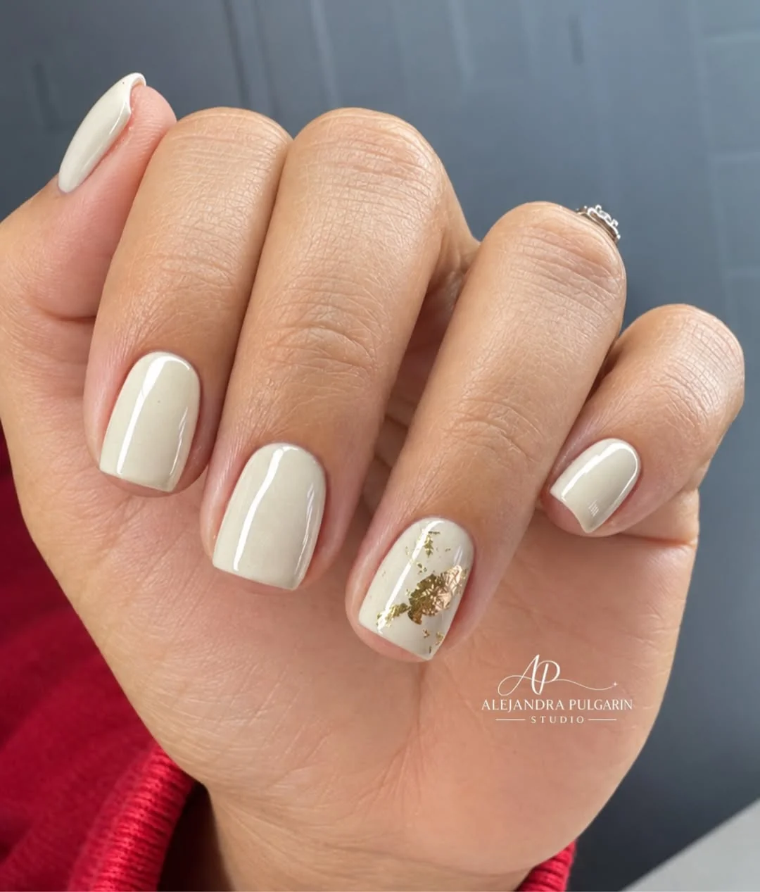 Short cream square nails with small gold accents
