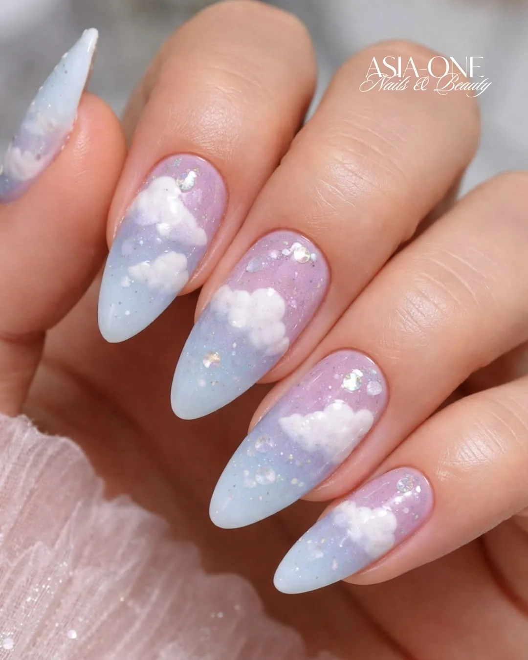 Pastel blue and lilac almond nails with fluffy white cloud art