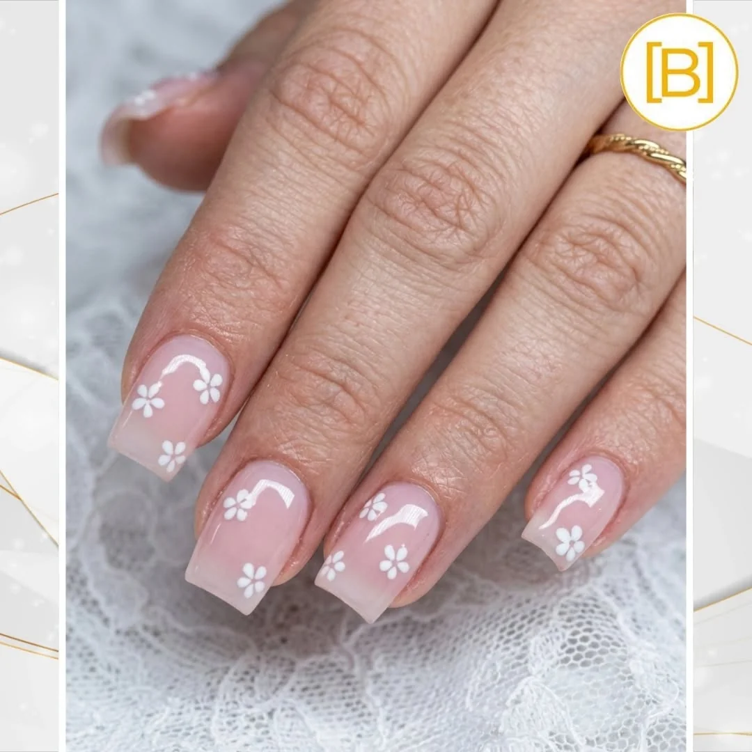 Sheer nude short nails with small white flowers