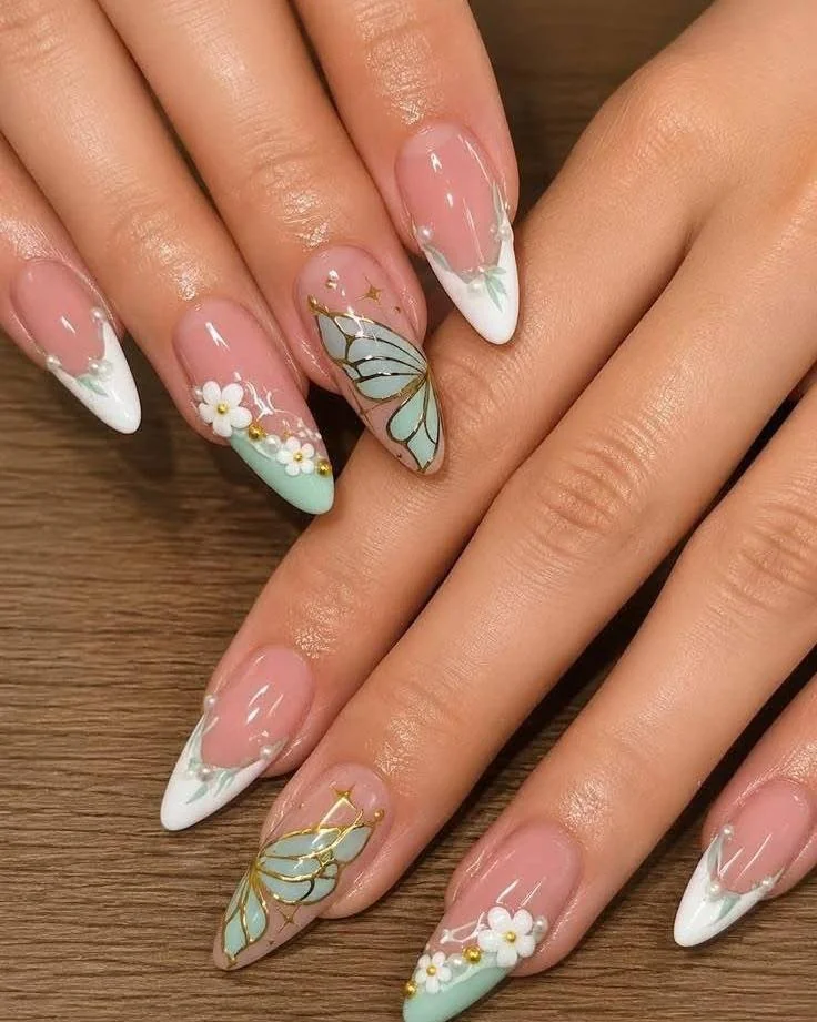 White French tip stiletto nails with mint butterfly and daisy accents