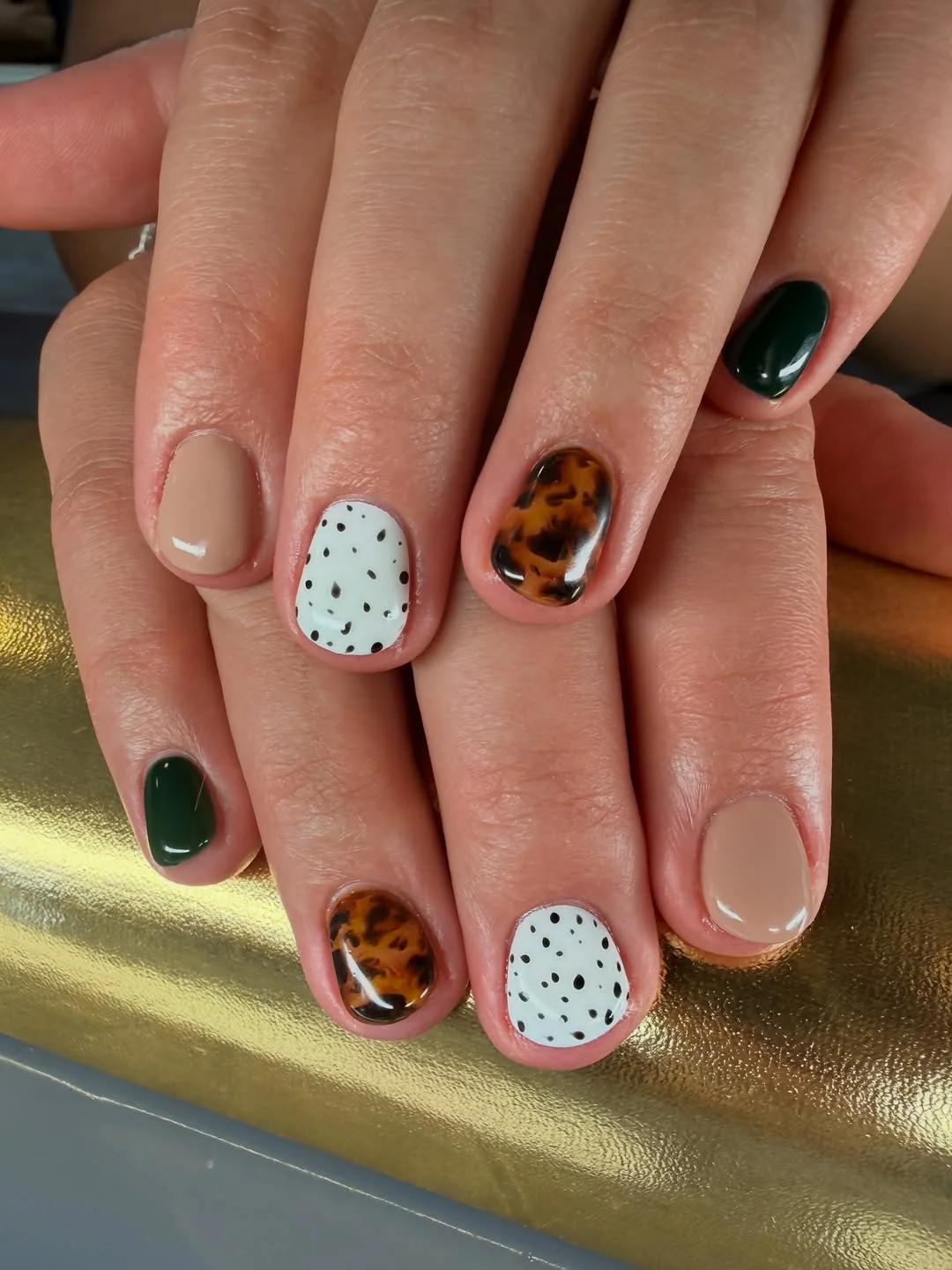 Short fall nails with tortoiseshell, speckled white and forest green accents