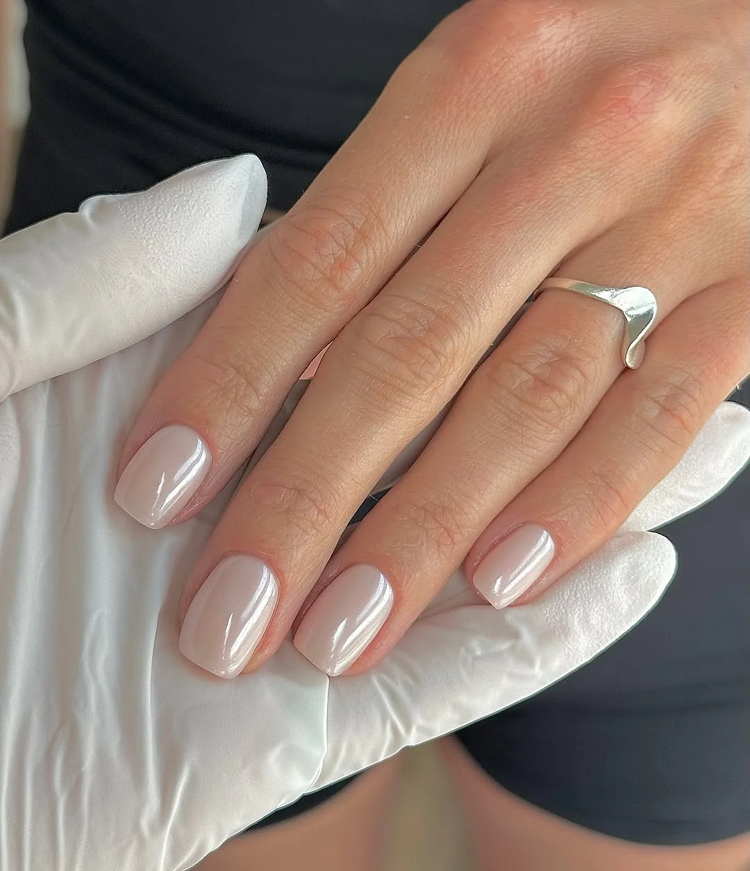 Glazed nude short almond nails with a glossy beach finish