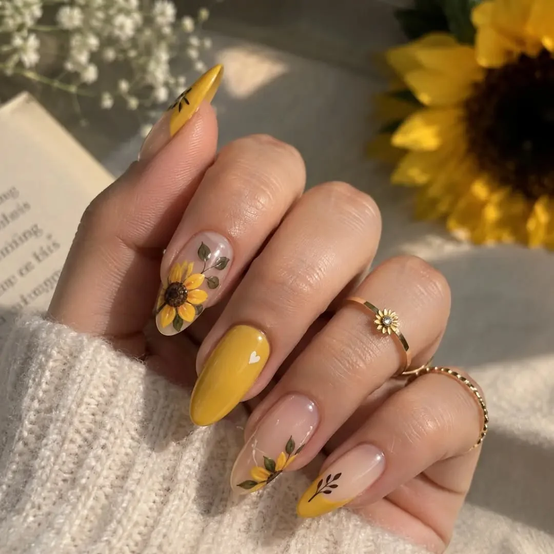 Mustard yellow almond nails with sunflower art on nude accent nails