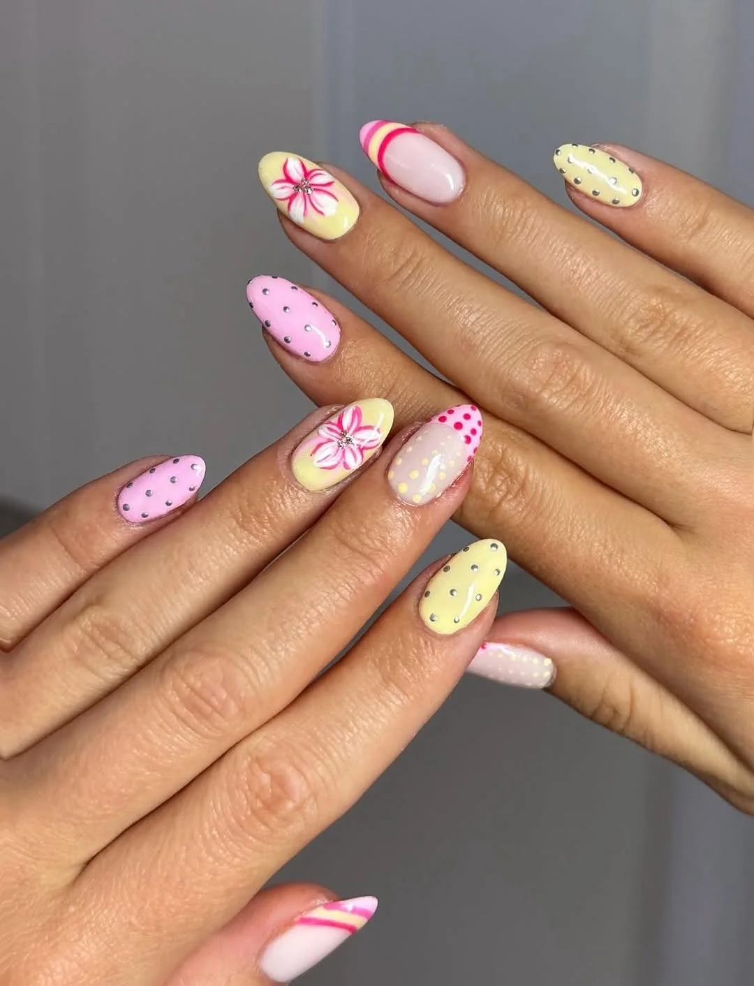 Colorful pastel short nails with dot flowers in yellow, pink and green