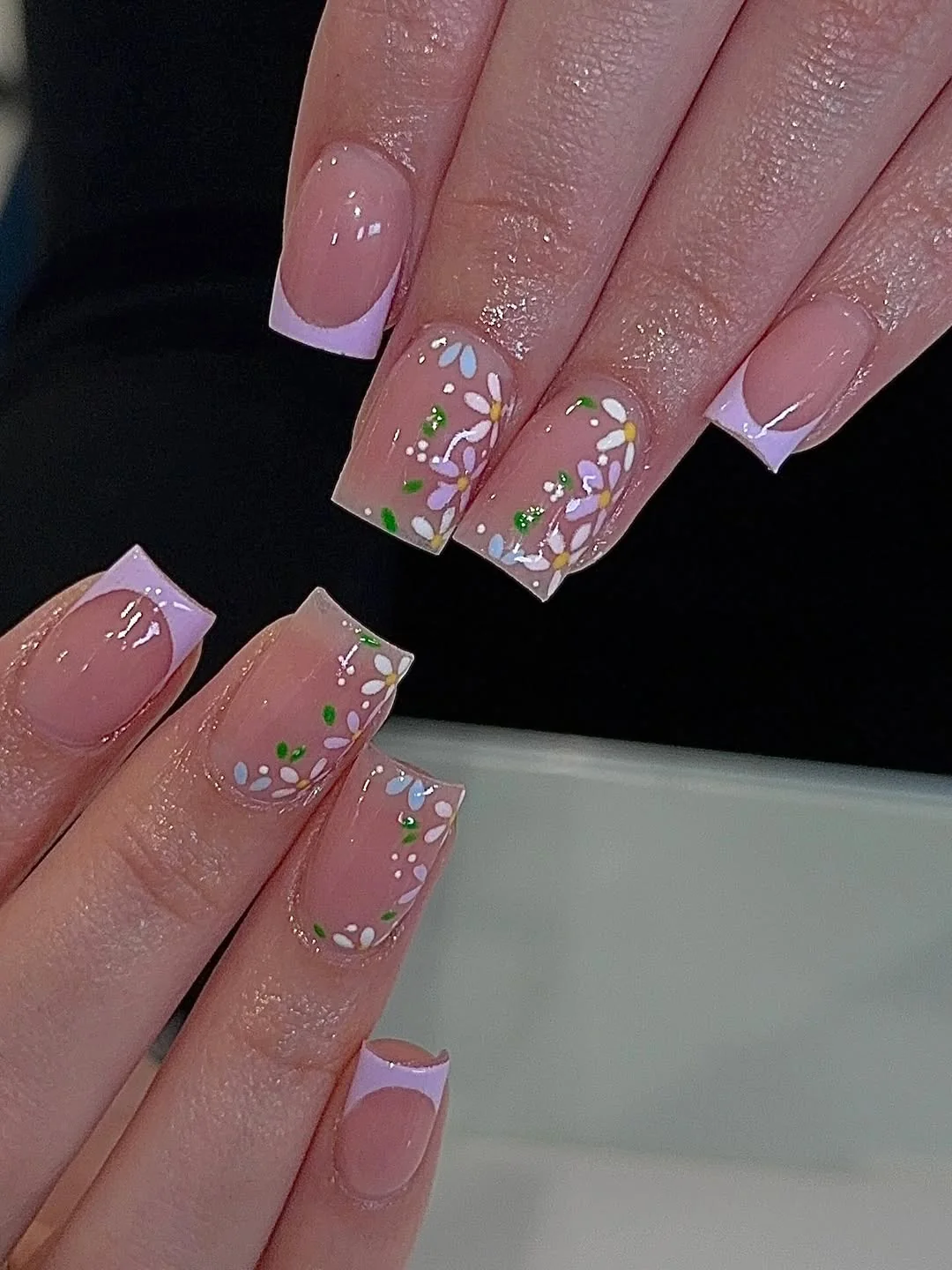 Short square nails with lilac French tips and tiny floral art