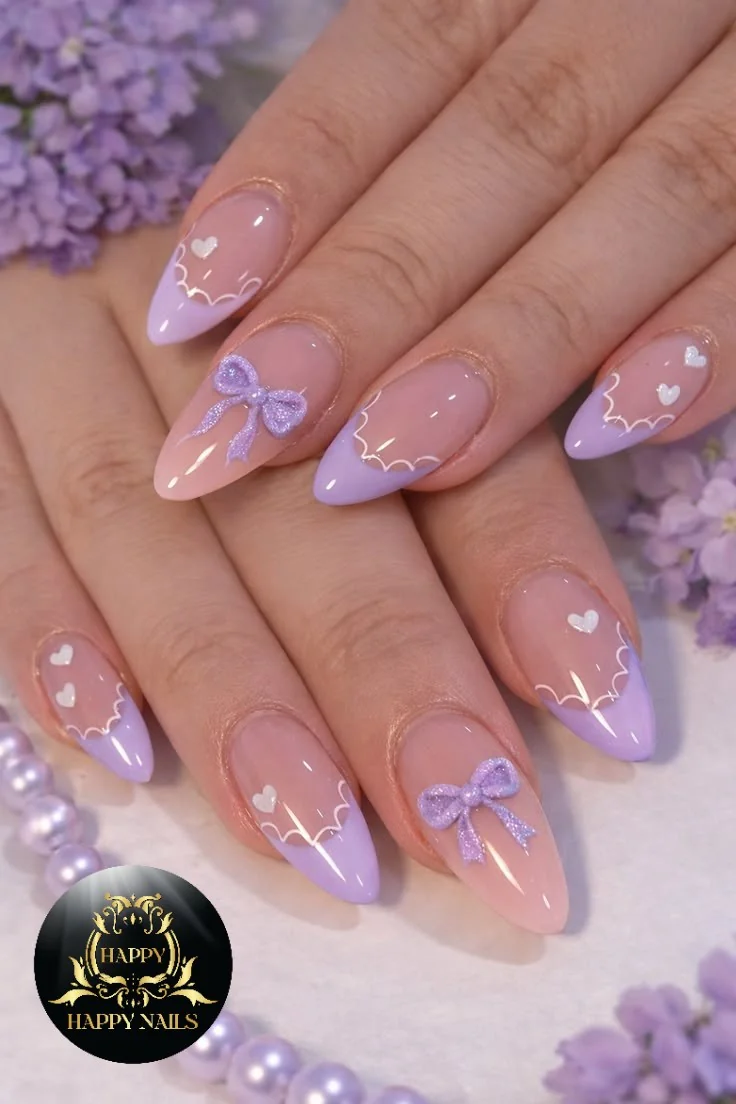 Lilac and nude almond nails with purple bow and heart accents
