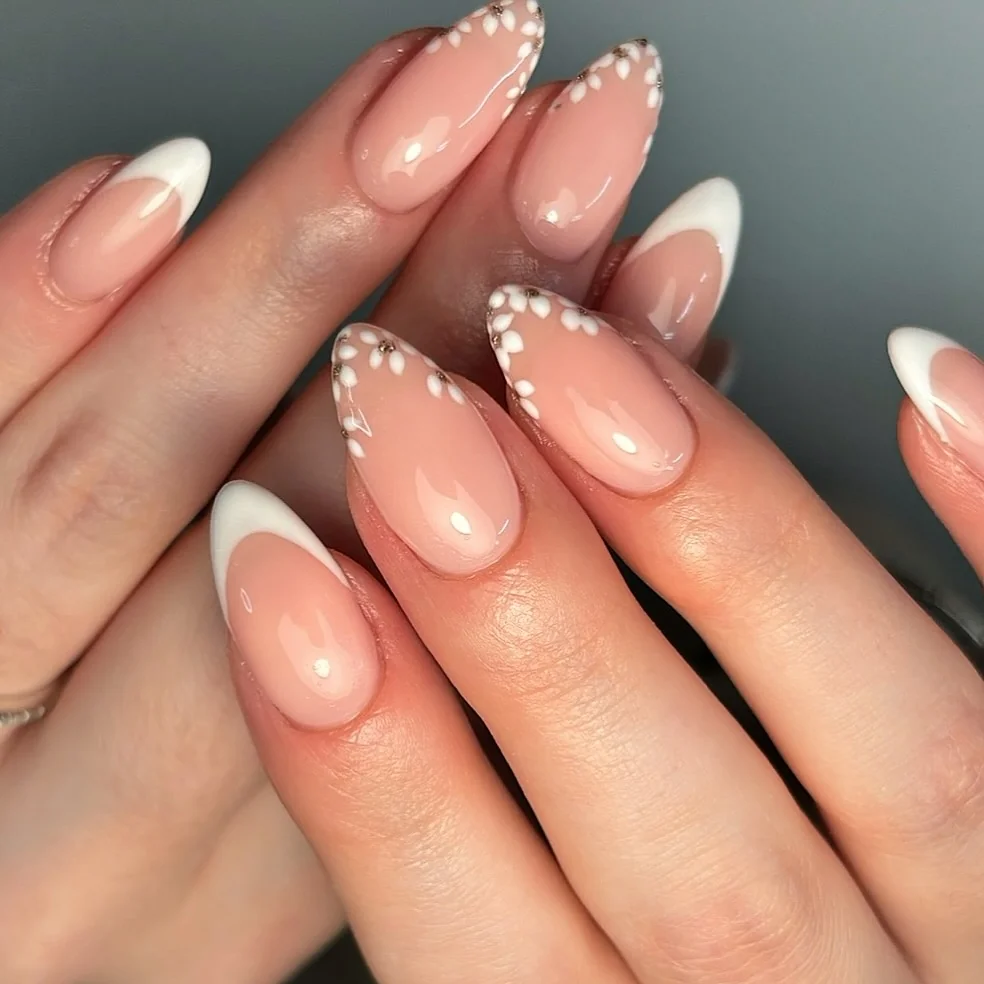 Almond nails with white French tips and white daisy dot art