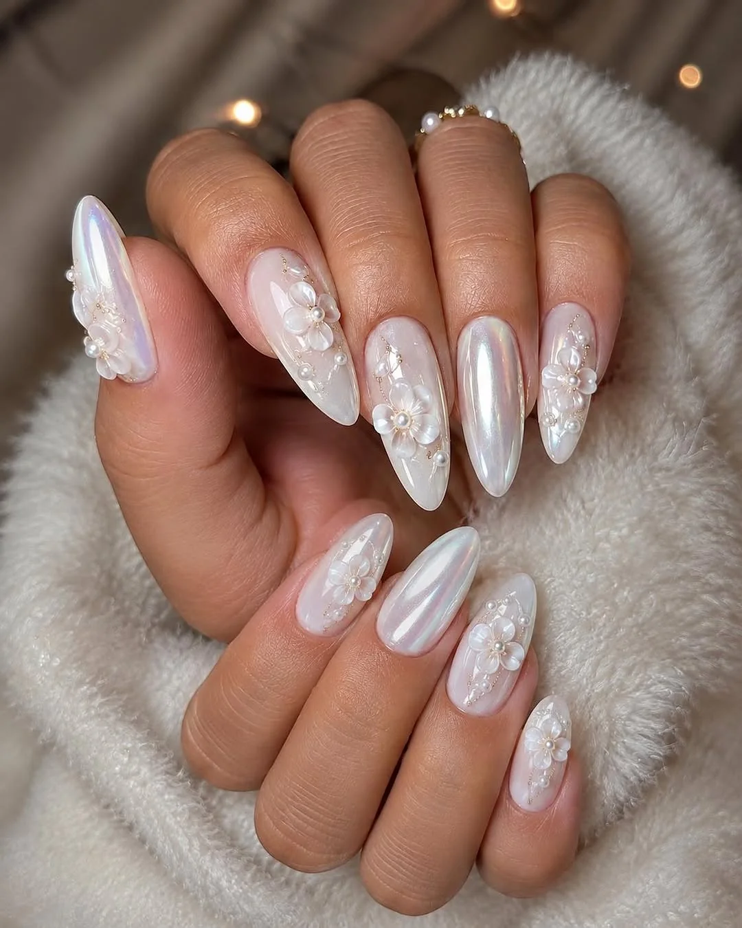 Pearl white almond nails with 3D flower accents