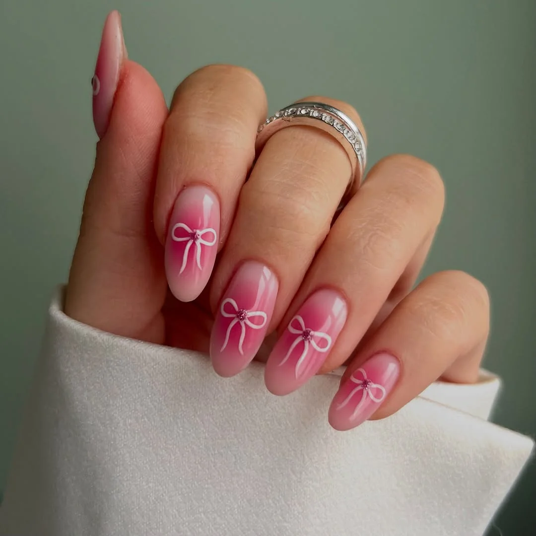 Pink ombré almond nails with pink bow art