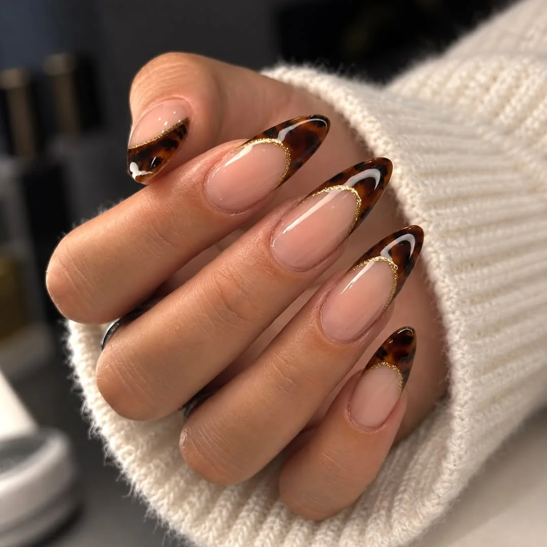 Almond nails with tortoiseshell side French tips and gold line detail