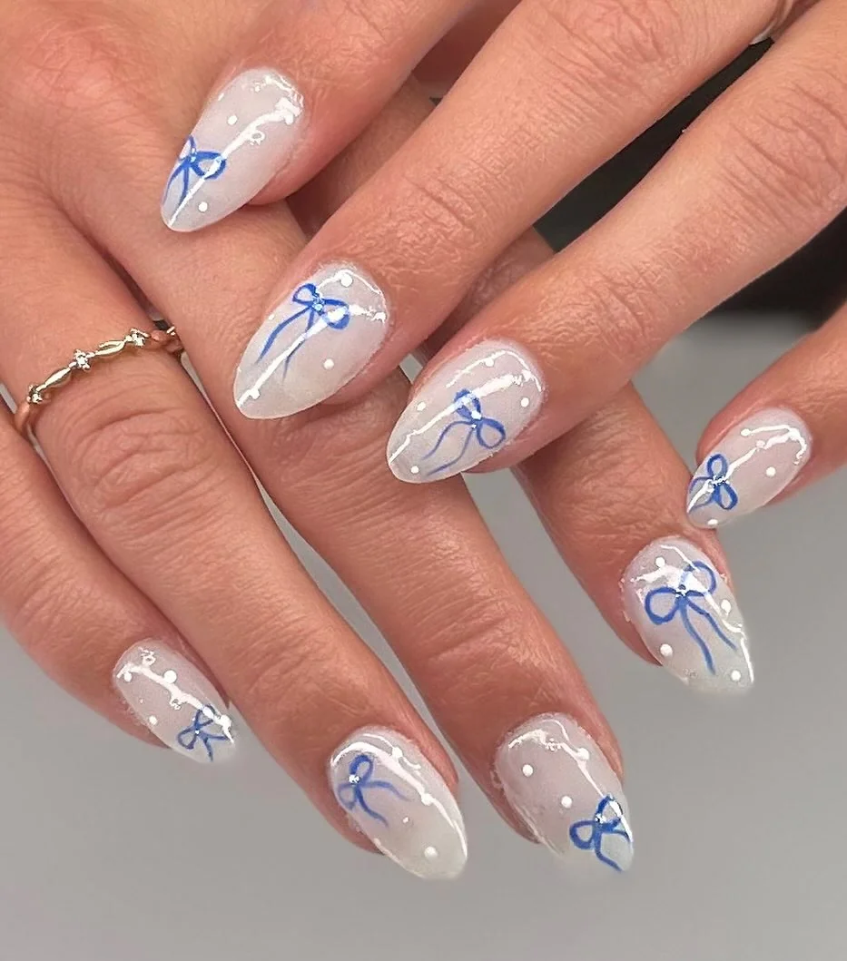 Milky white almond nails with blue ribbon bow art