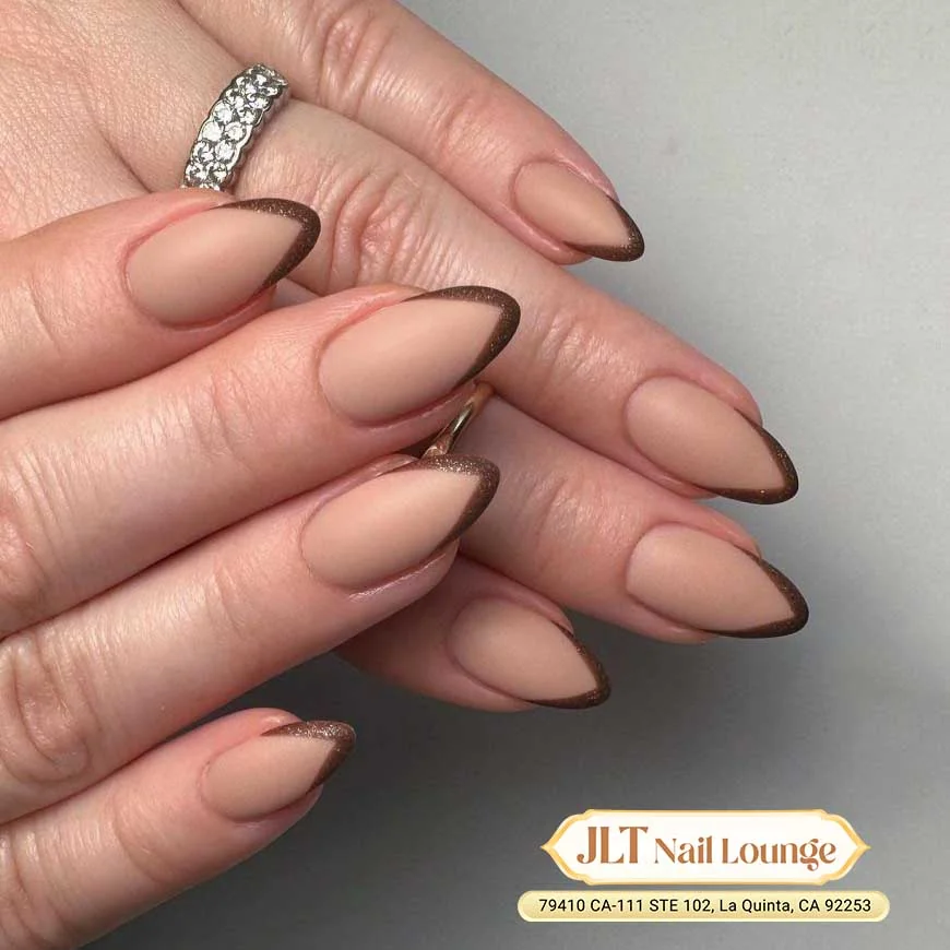 Sheer nude almond nails with thin brown outline French tips