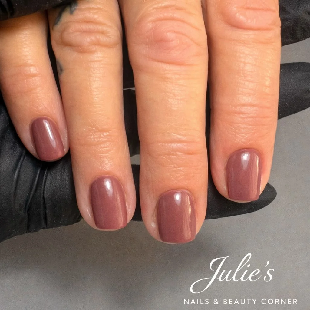 Short muted mauve brown nails with a glossy finish