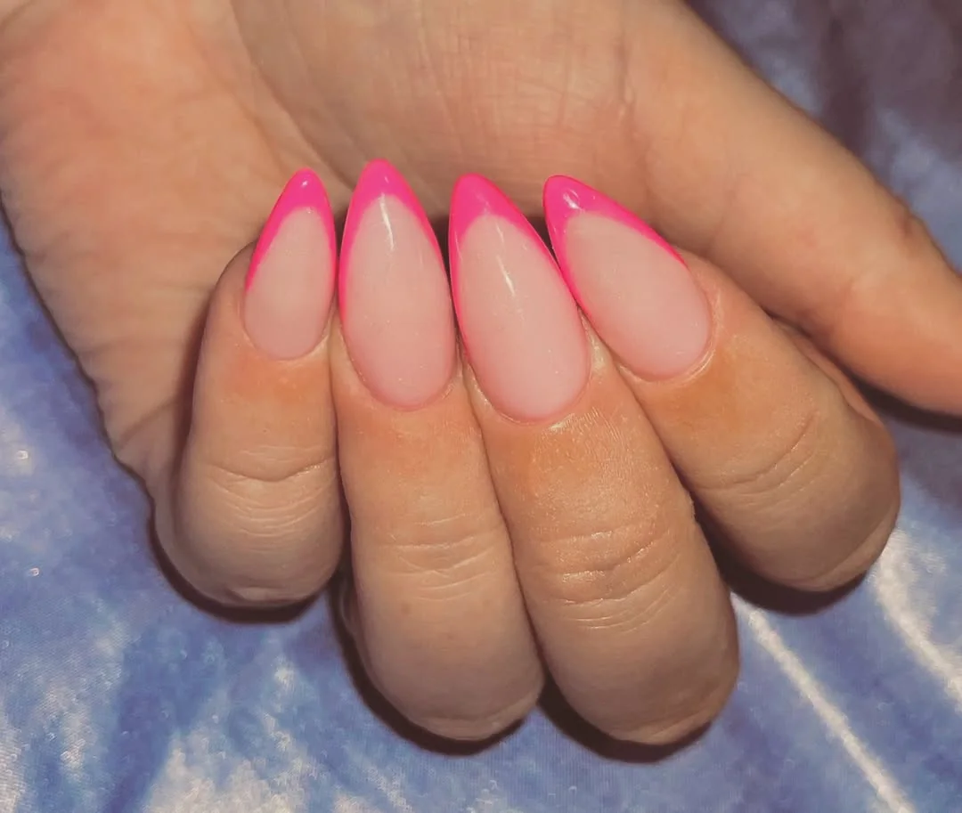 Hot pink French tip almond nails on sheer nude base